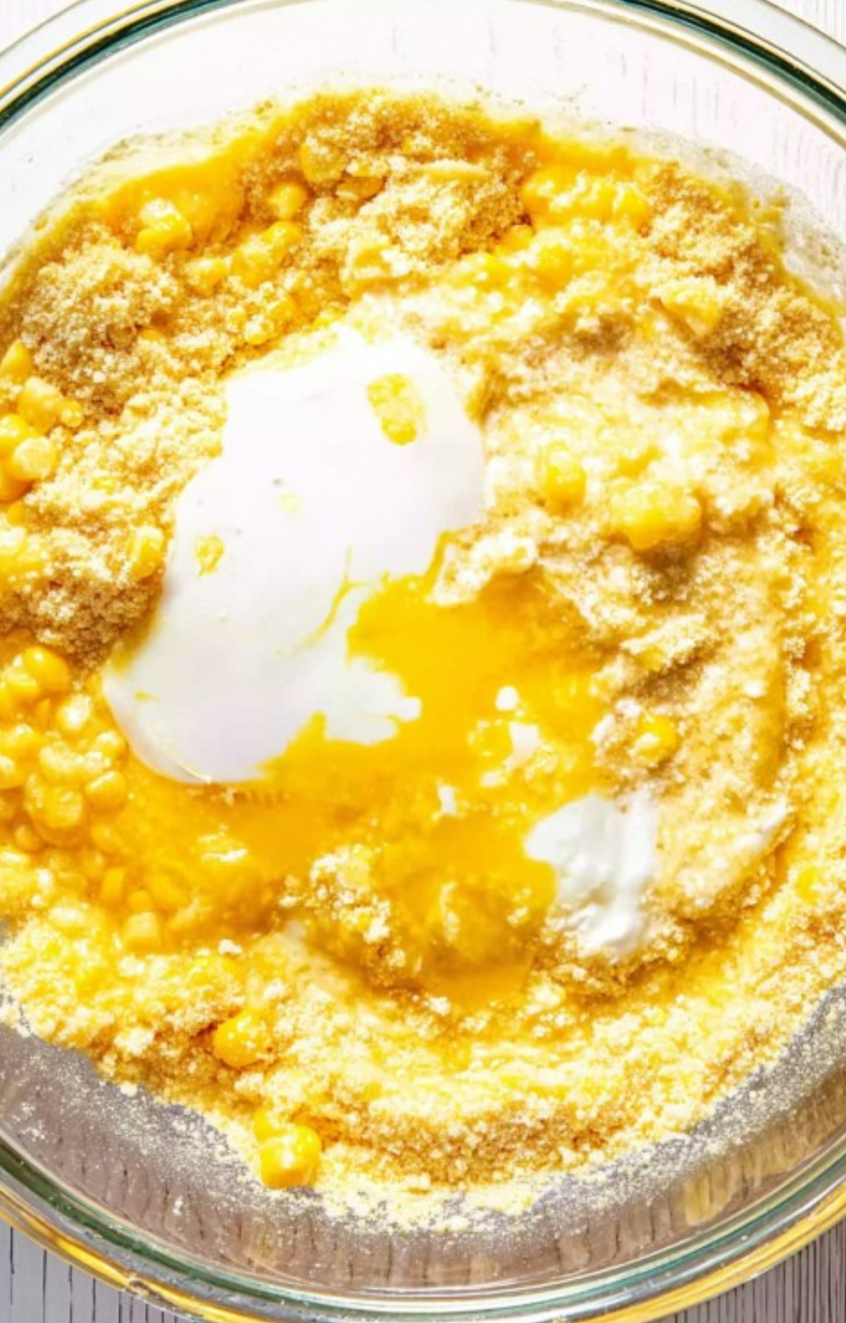 Top-down view of a glass bowl filled with the creamy, chunky batter for Corn Casserole Jiffy Easy, ready to bake for a cozy, crowd-pleasing side dish.