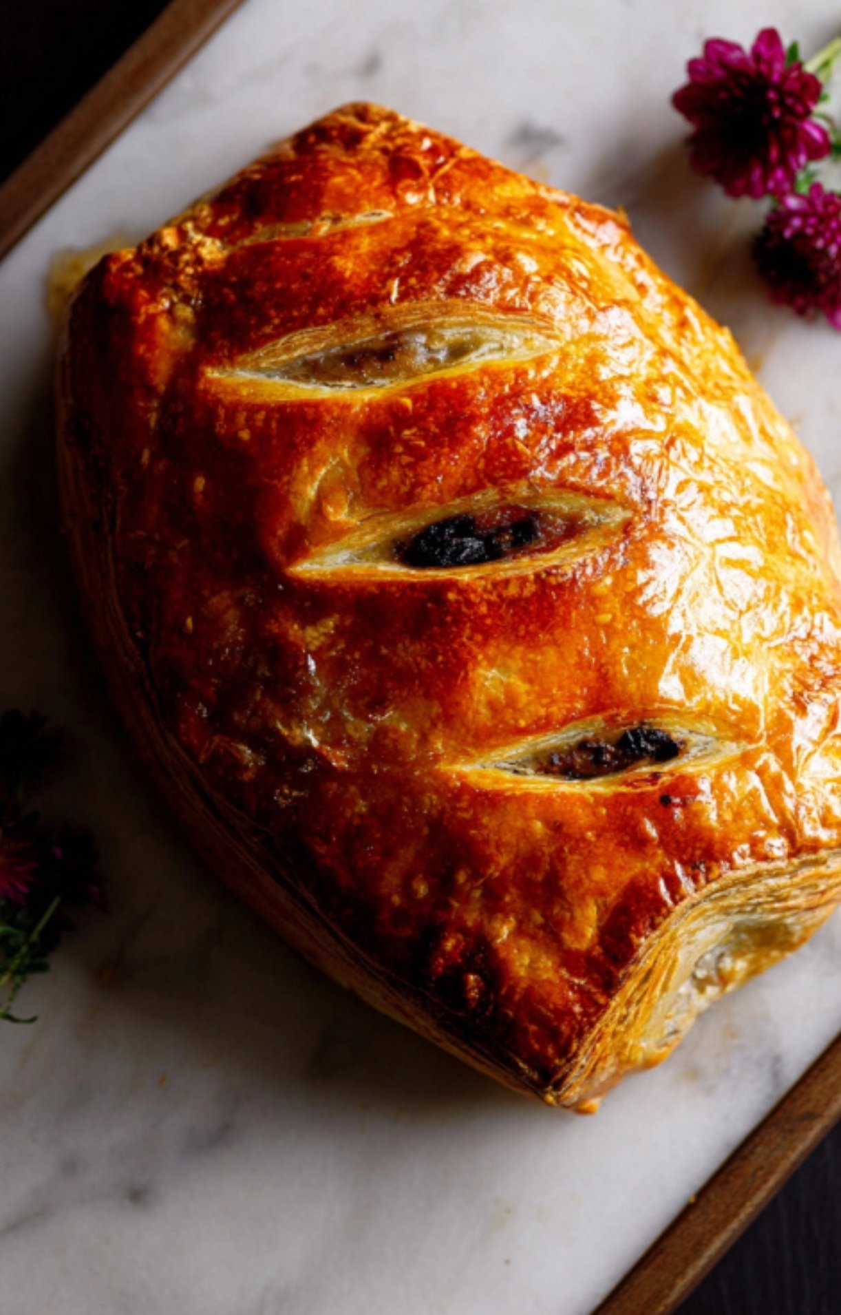 Crispy, golden-brown beef Wellington pastry baked to perfection on a marble board, perfect for special occasions or Christmas dinner.
