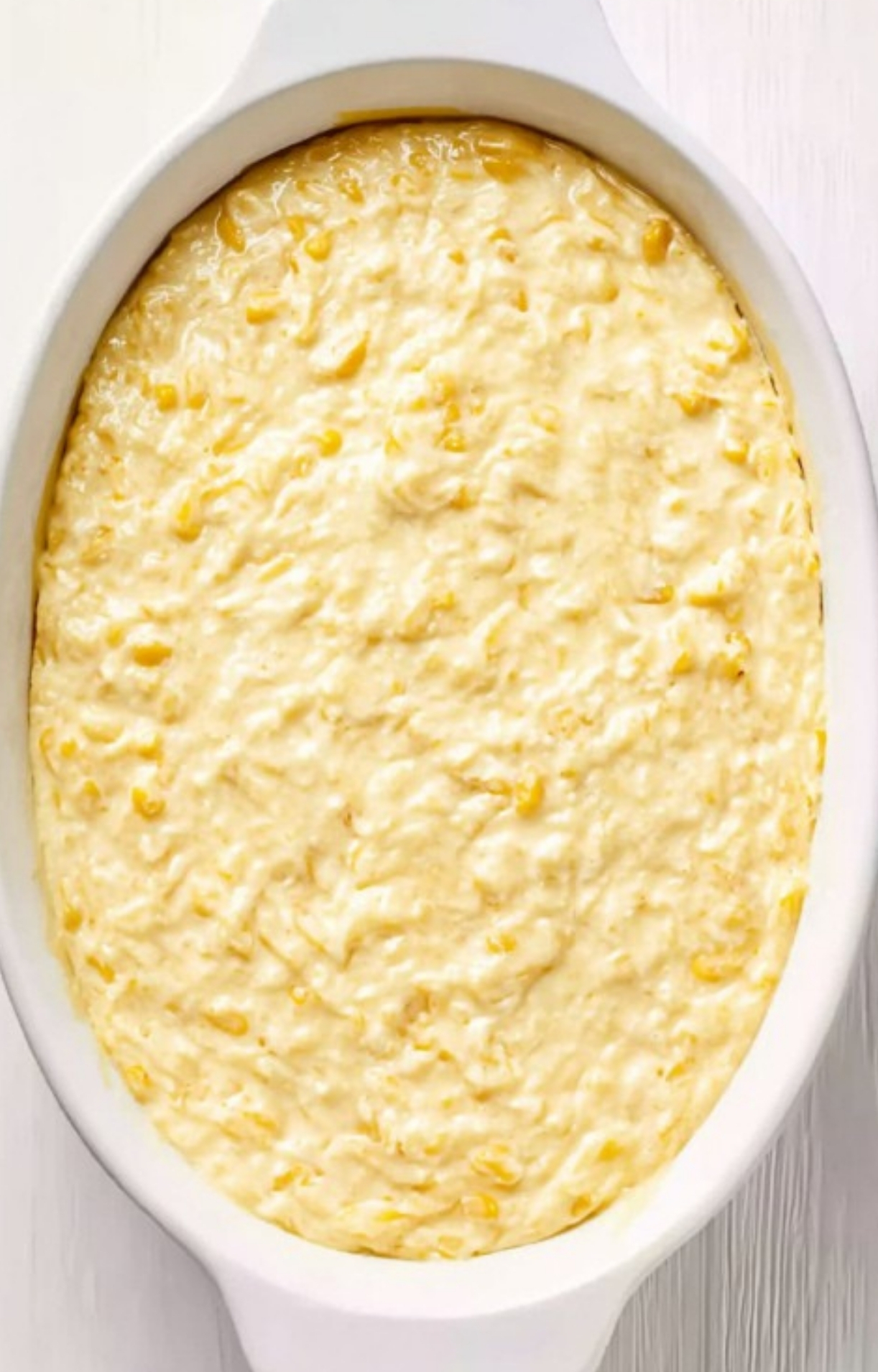 A white baking dish filled with unbaked Corn Casserole Jiffy Easy batter, showing the creamy and chunky mixture before baking, perfect for quick weeknight dinners.