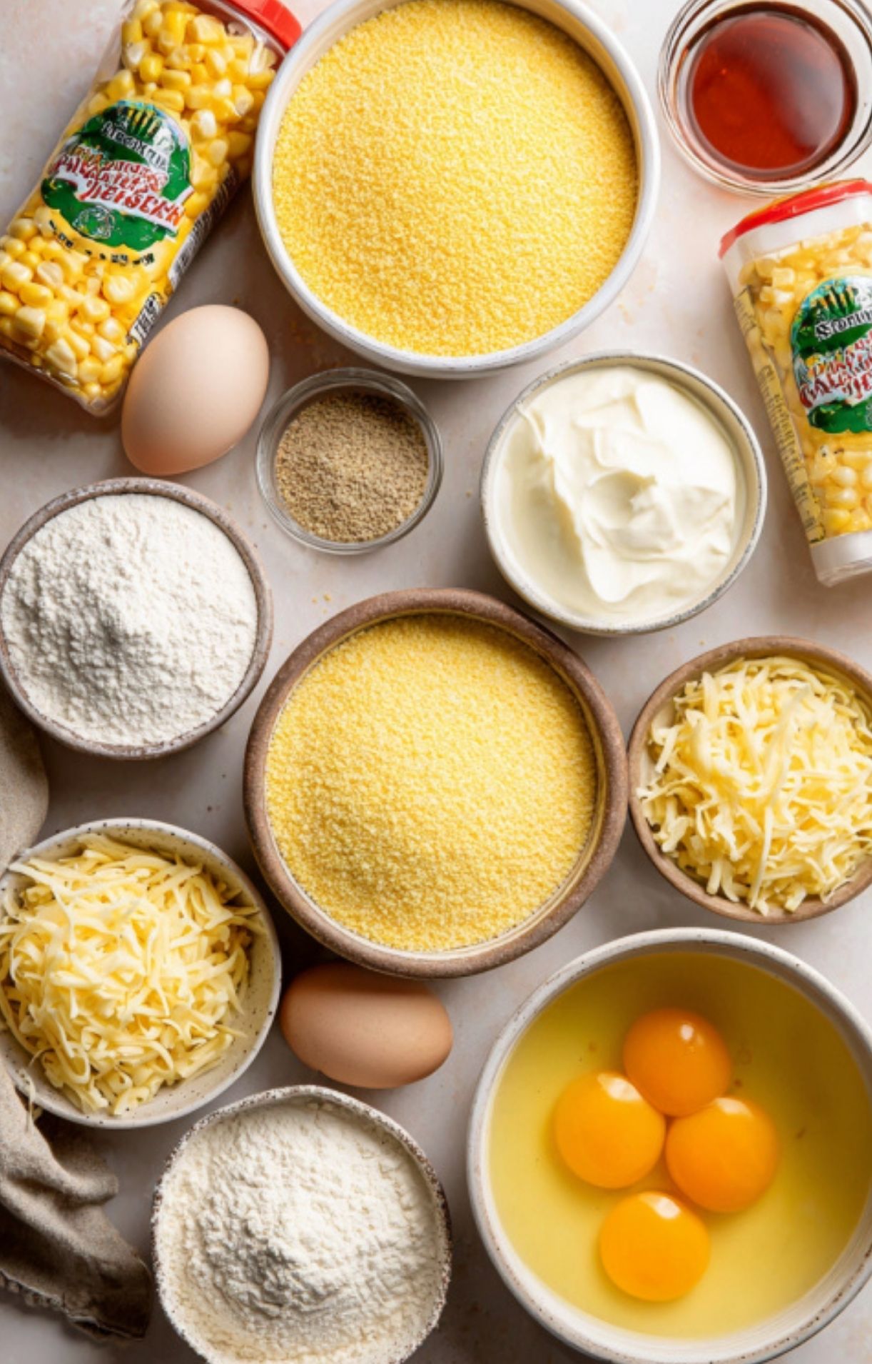 Freshly baked corn pudding casserole in a white dish with a crispy, caramelized top and visible sweet corn kernels. A classic Southern recipe for holidays or comfort food nights.