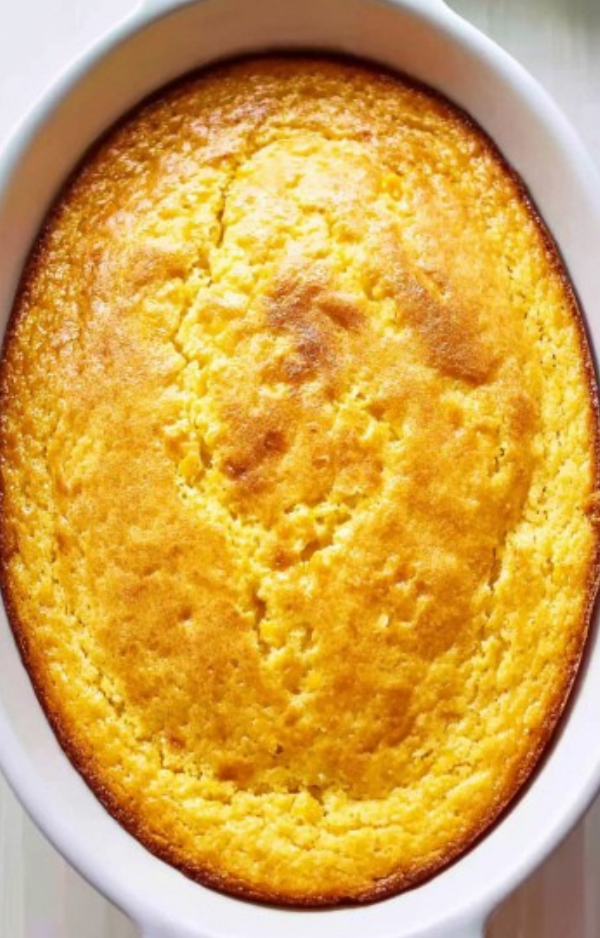 Corn Casserole Jiffy Easy just out of the oven in an oval baking dish, with a golden brown top and slightly cracked surface, perfect for holiday or Sunday dinner tables.