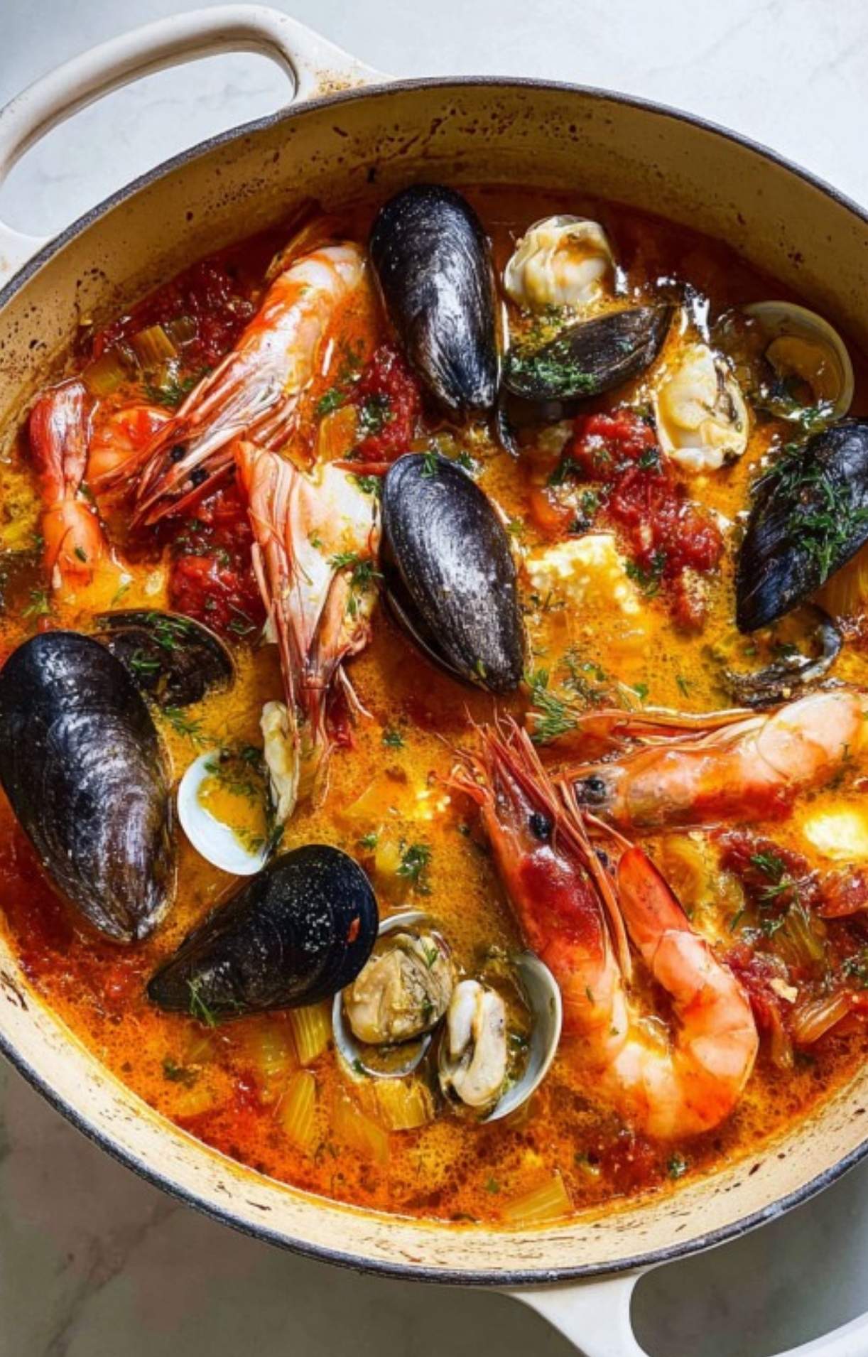 Homemade bouillabaisse with whole prawns, mussels, clams, and cod simmered in a fragrant tomato broth. A must-try classic French recipe for seafood lovers and festive dinners.