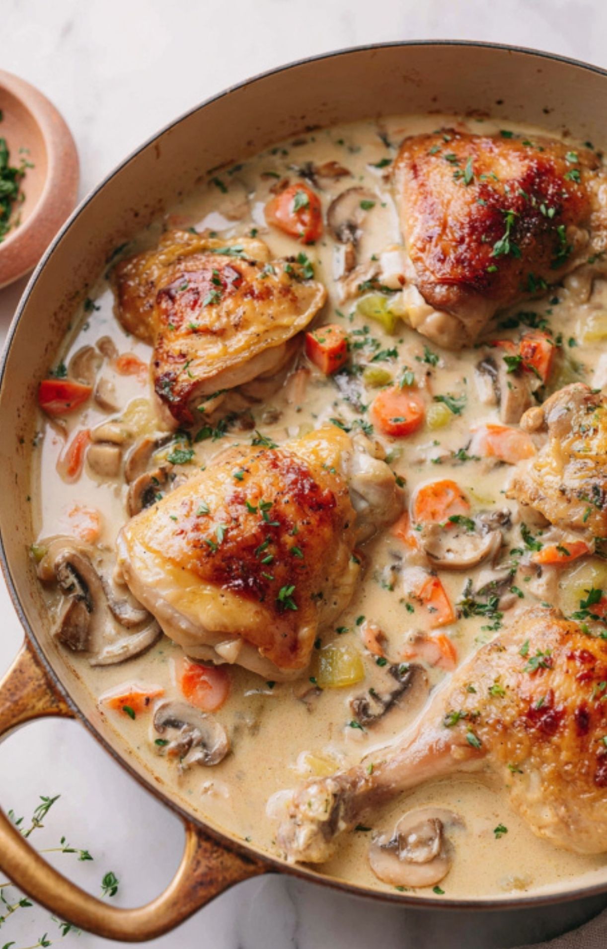 Chicken thighs and drumsticks simmered in a creamy sauce with carrots and mushrooms.