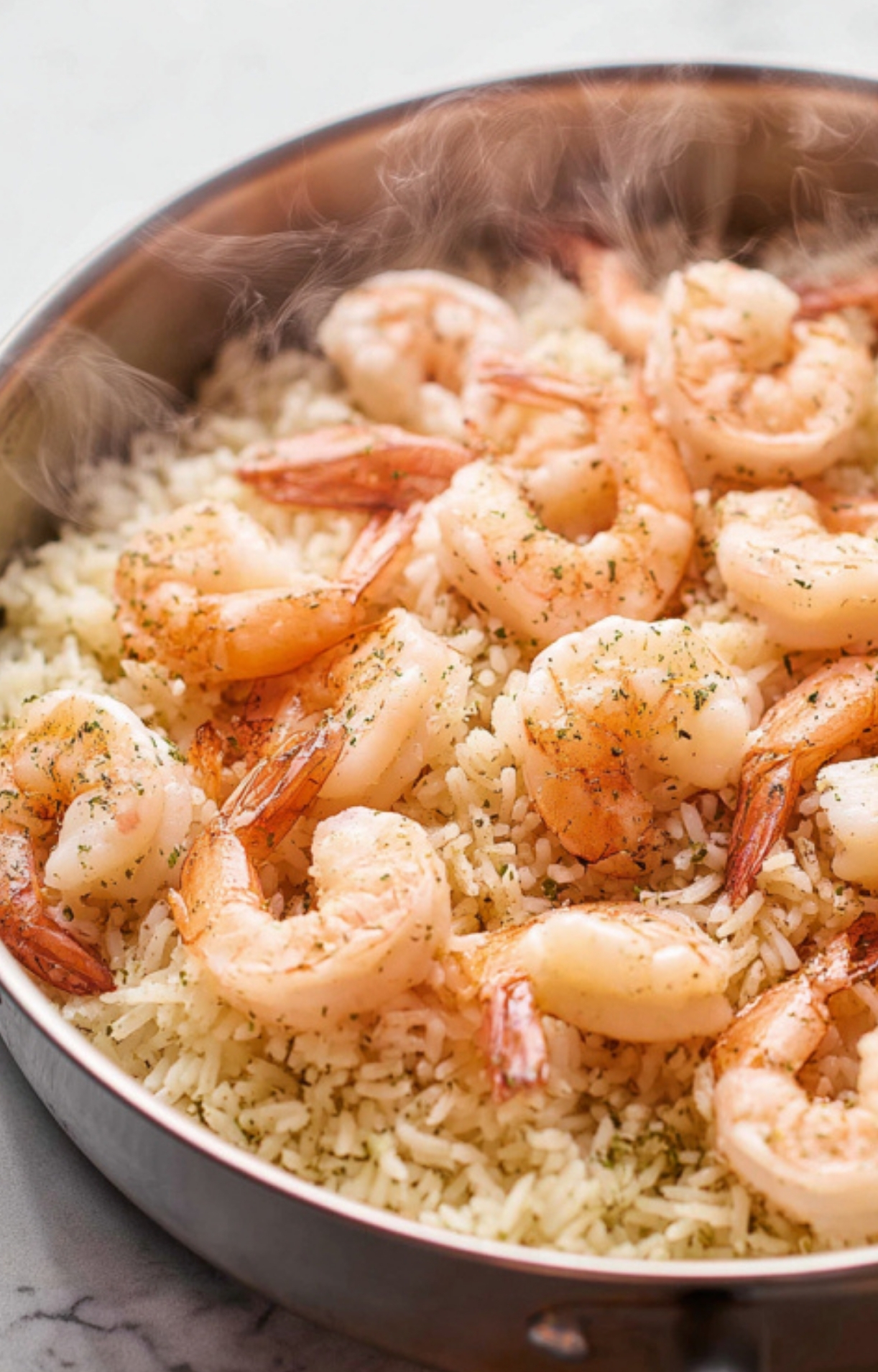 Steaming pan of cooked shrimp and fluffy rice, perfect for a healthy week night dinner, quick seafood meals, and one-pan family recipes.