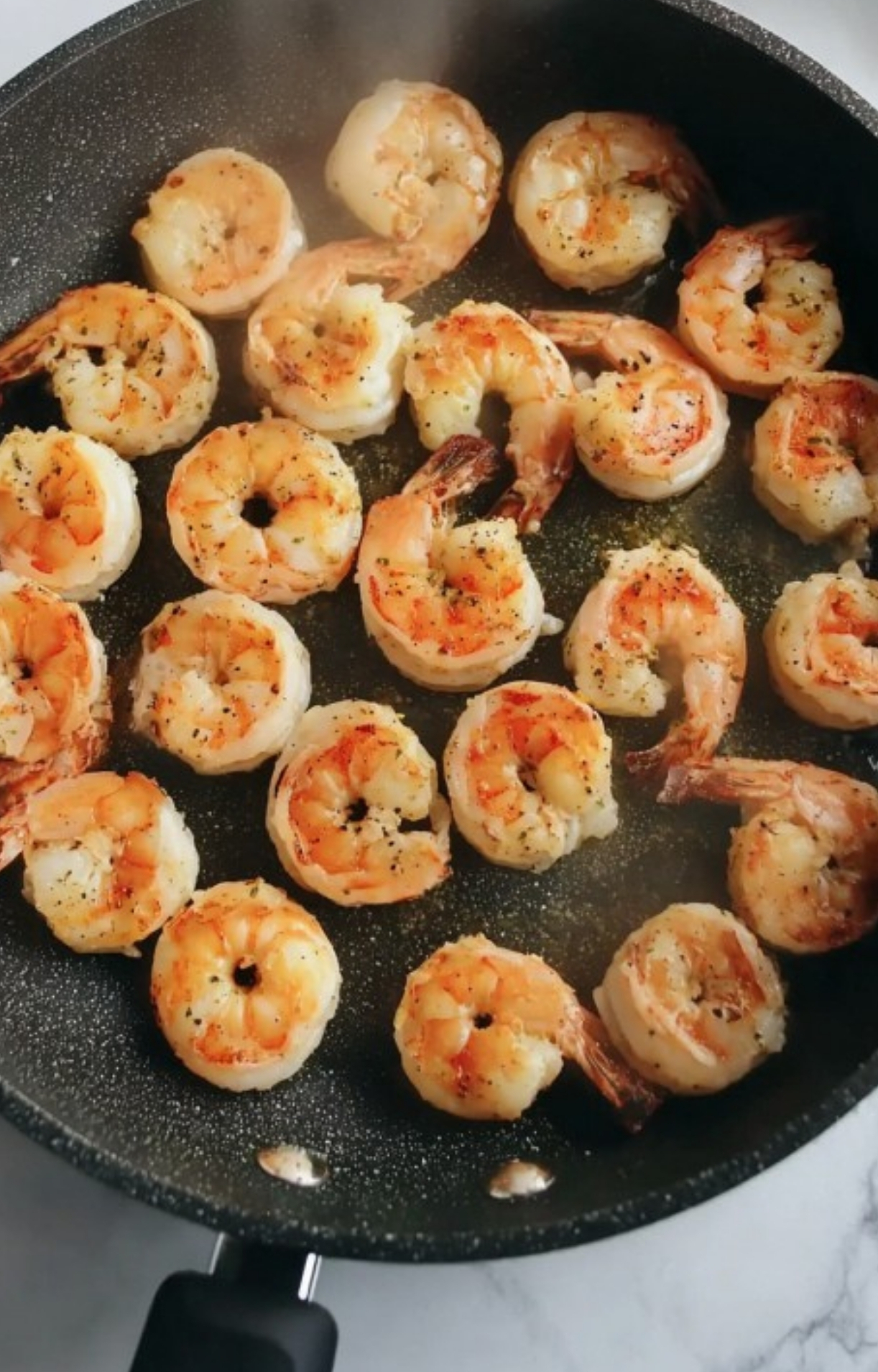 Cooked shrimp in a skillet, seasoned and sizzling – fast protein for healthy dinners or meal prep