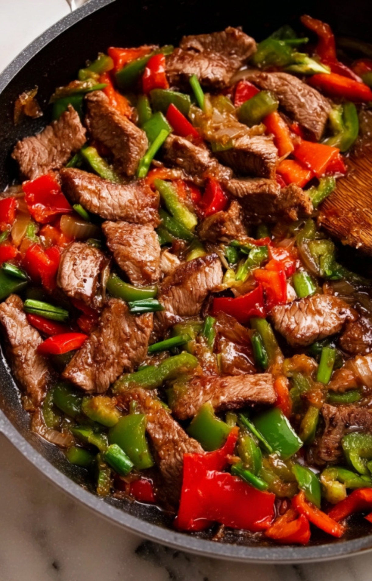 Juicy steak, red and green bell peppers, and savory sauce cooked in one pan.