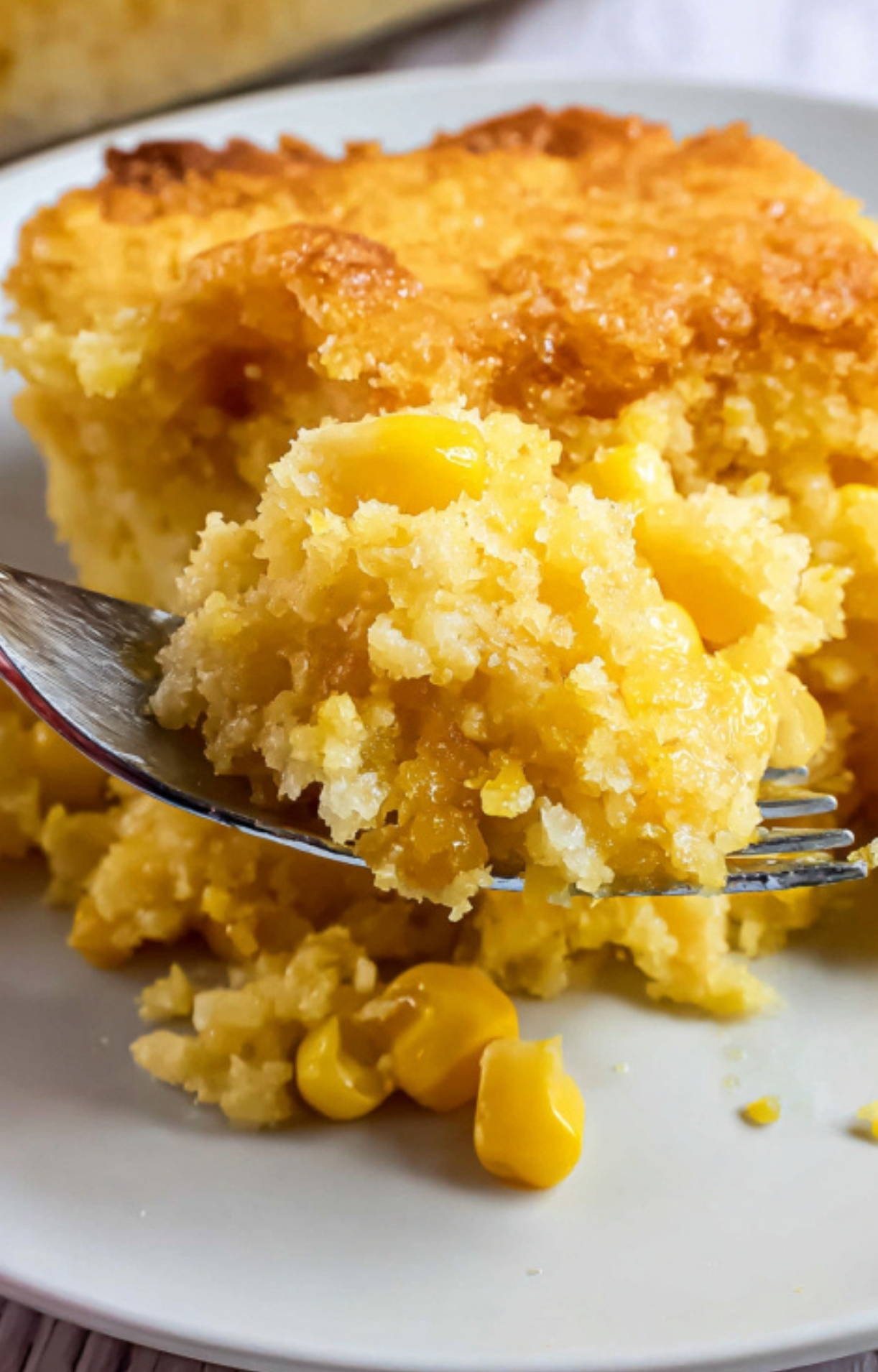 A forkful of Corn Casserole Jiffy Easy lifted from a plate, showing moist texture and whole sweet corn kernels, perfect for comfort food lovers and potluck side dishes.