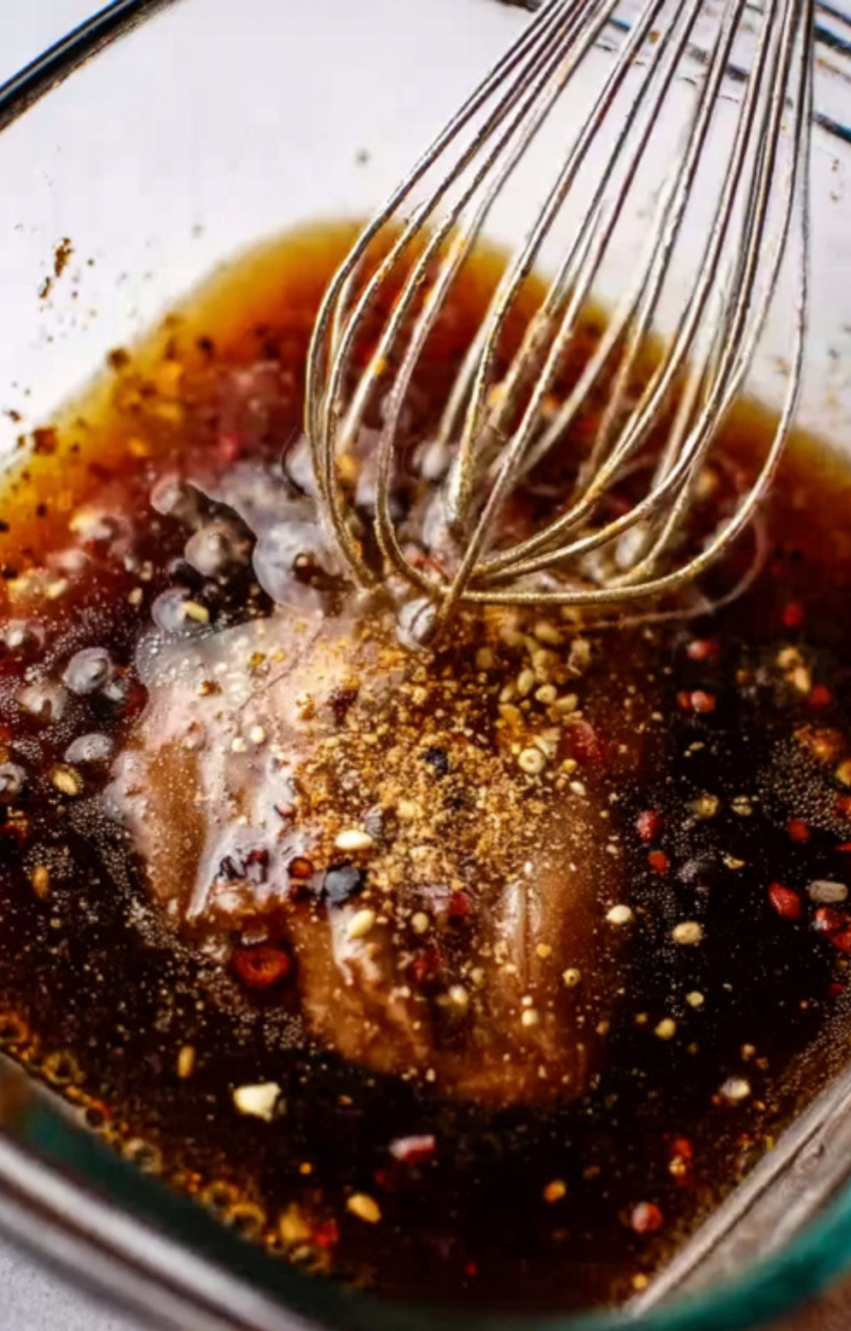 Sweet and savory steak marinade whisked in a glass bowl, packed with soy sauce, spices, and garlic for juicy steak