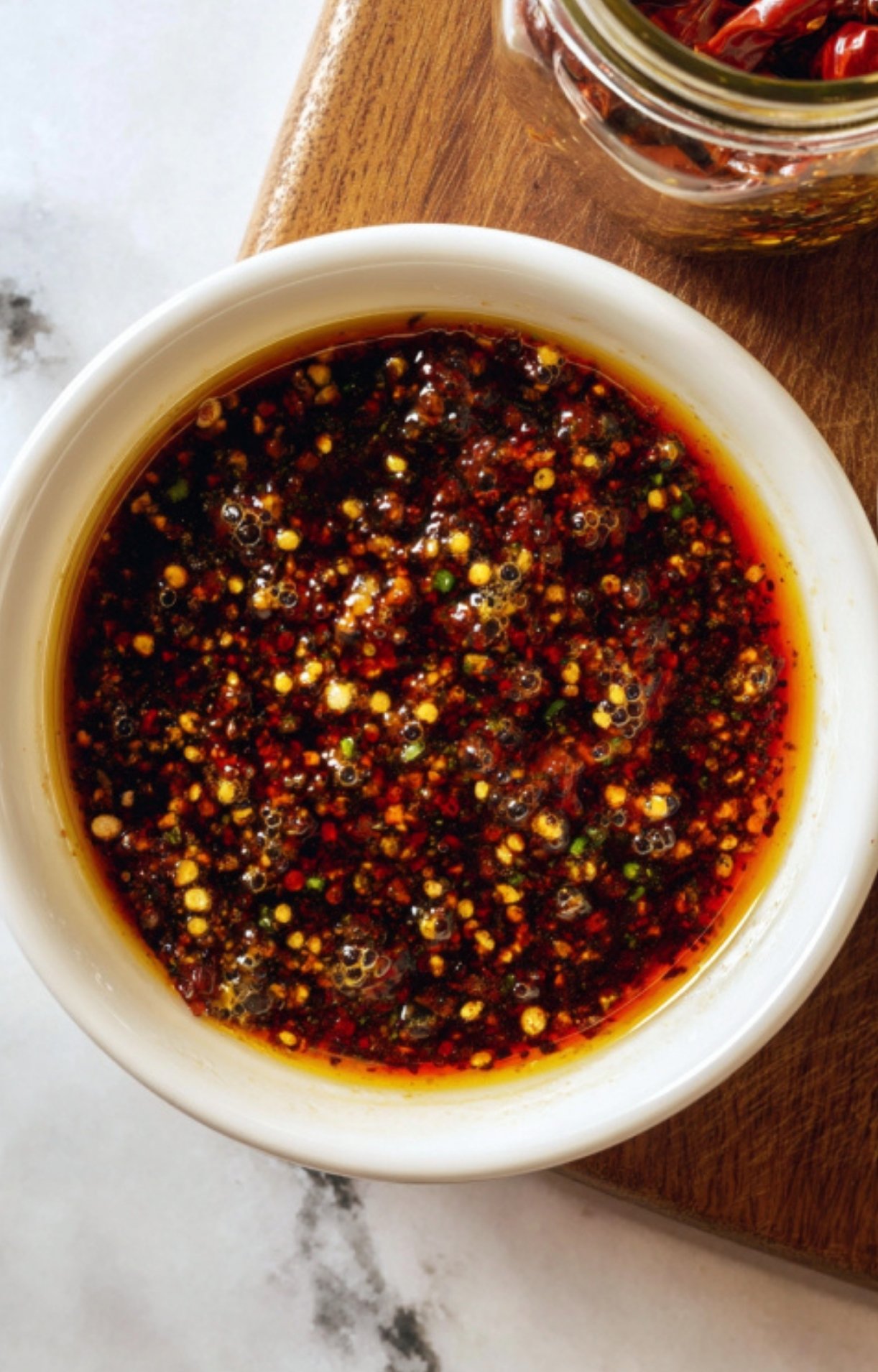 Spicy chili garlic sauce in a white bowl, perfect for adding bold Asian-inspired flavor to Shaved Beef And Broccoli stir fry.