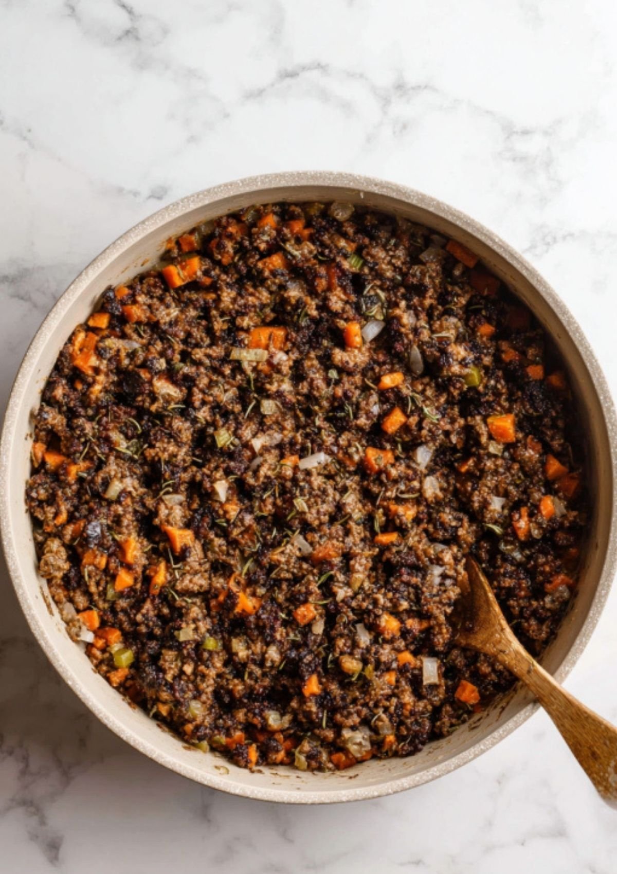 Vegan Wellington filling cooked and ready in the skillet, packed with carrots, onions, mushrooms, and herbs. Great for Christmas and Thanksgiving vegan meals.