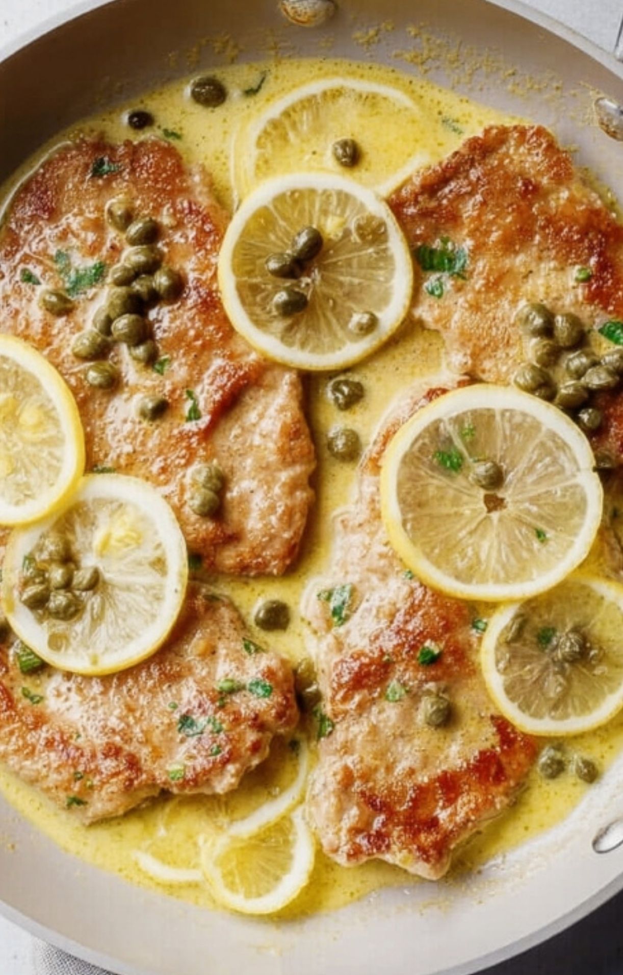 Golden veal cutlets simmering in a bright lemon and caper sauce. Simple, quick, and perfect for homemade Italian comfort food.