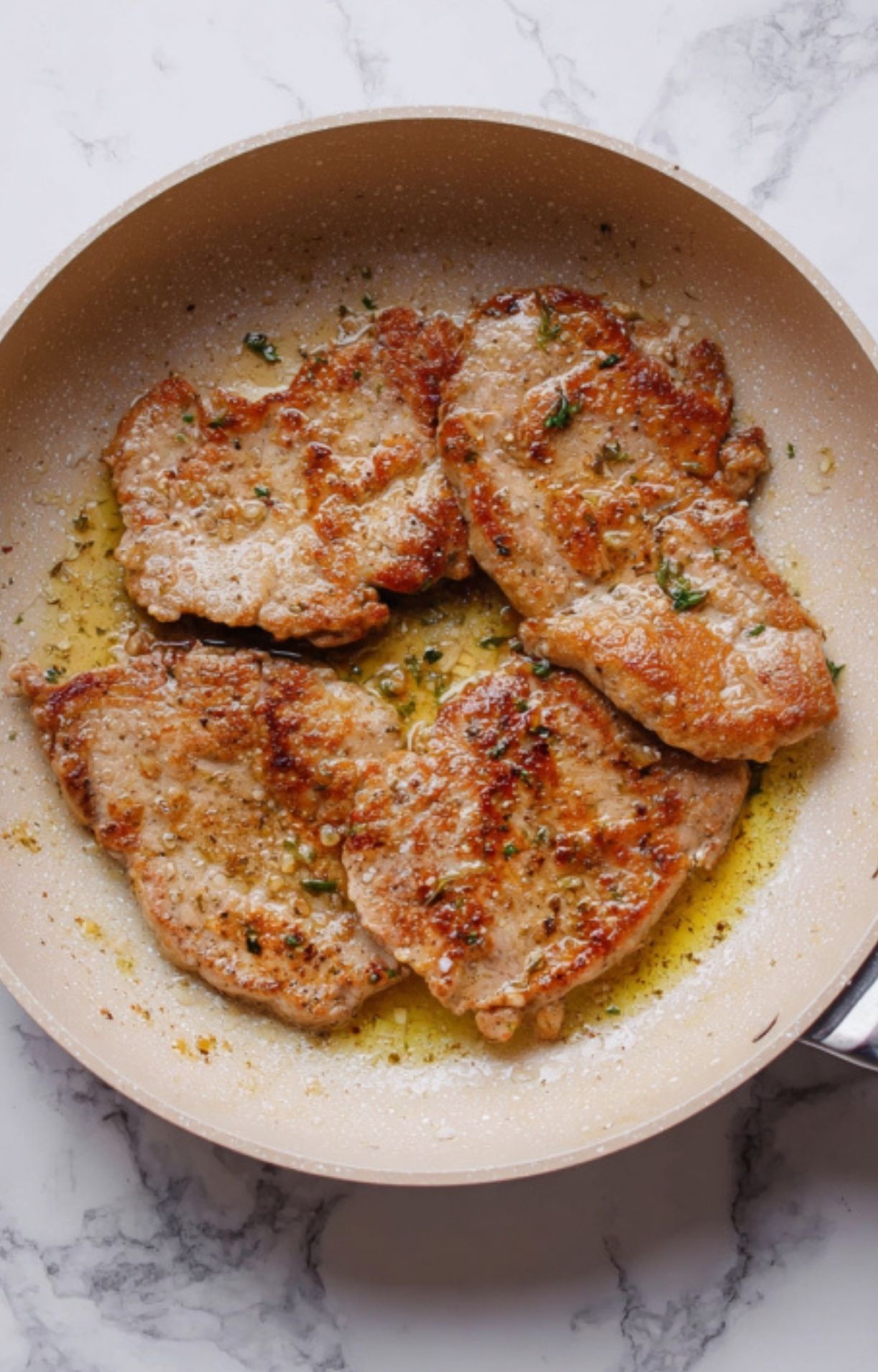 Veal cutlets simmering in creamy lemon sauce with capers and lemon slices. Classic Italian recipe for quick family meals.