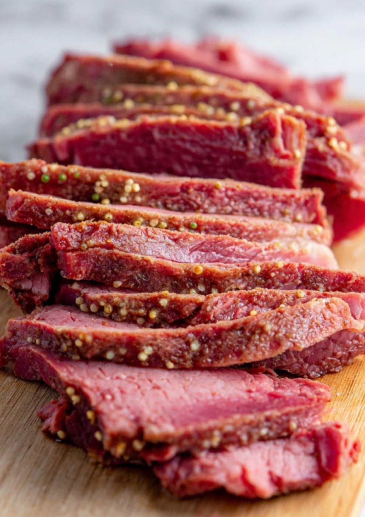 Close-up of perfectly sliced corned beef brisket showing juicy texture and spice crust. Learn the best way to slice for soft, flavorful results in your pressure cooker recipes.