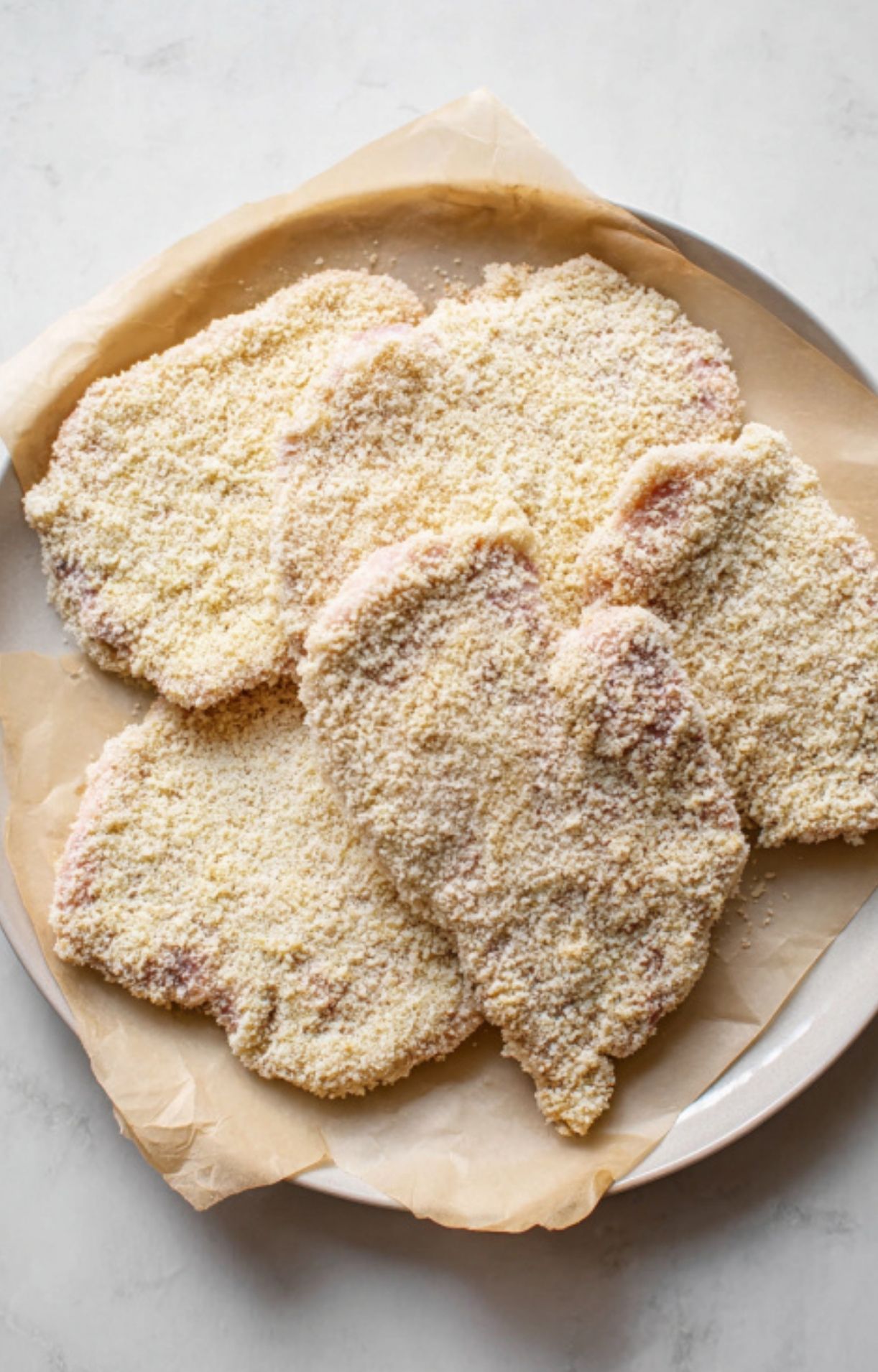 Breaded veal cutlets ready to cook for classic veal scallopini Milanese. Easy Italian dinner idea for crispy cutlets.
