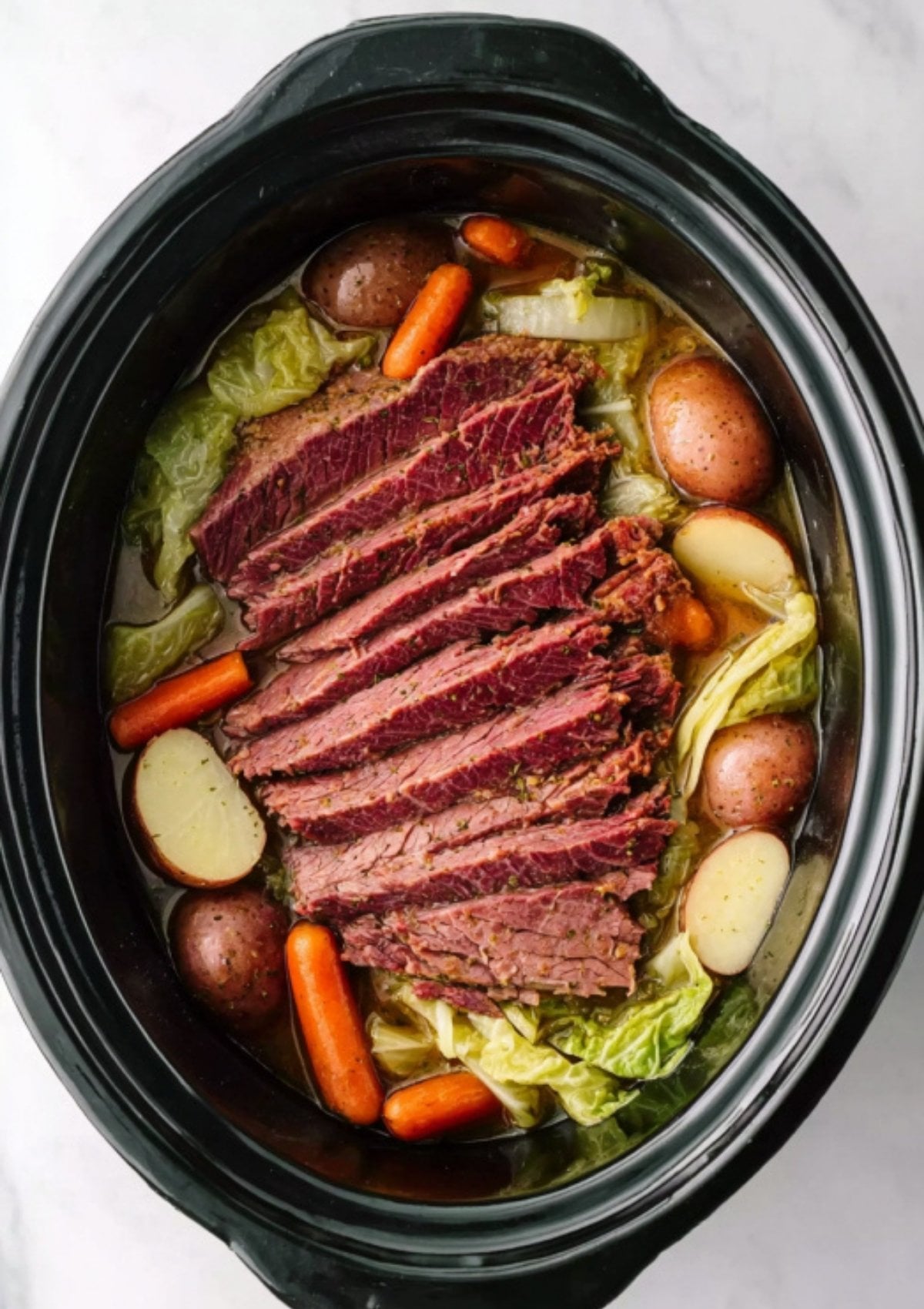 Tender corned beef brisket with red potatoes, carrots, and cabbage cooked together in a slow cooker. Classic St. Patrick’s Day meal made simple, perfect for family dinners and cozy gatherings.