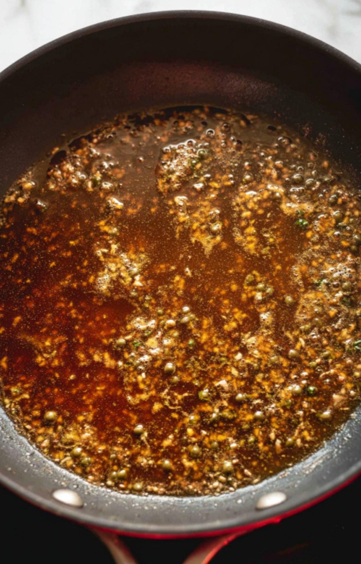 Simmering pan of white wine mushroom sauce, full of flavor for pouring over veal scallopini. Easy homemade sauce for classic Italian recipes.