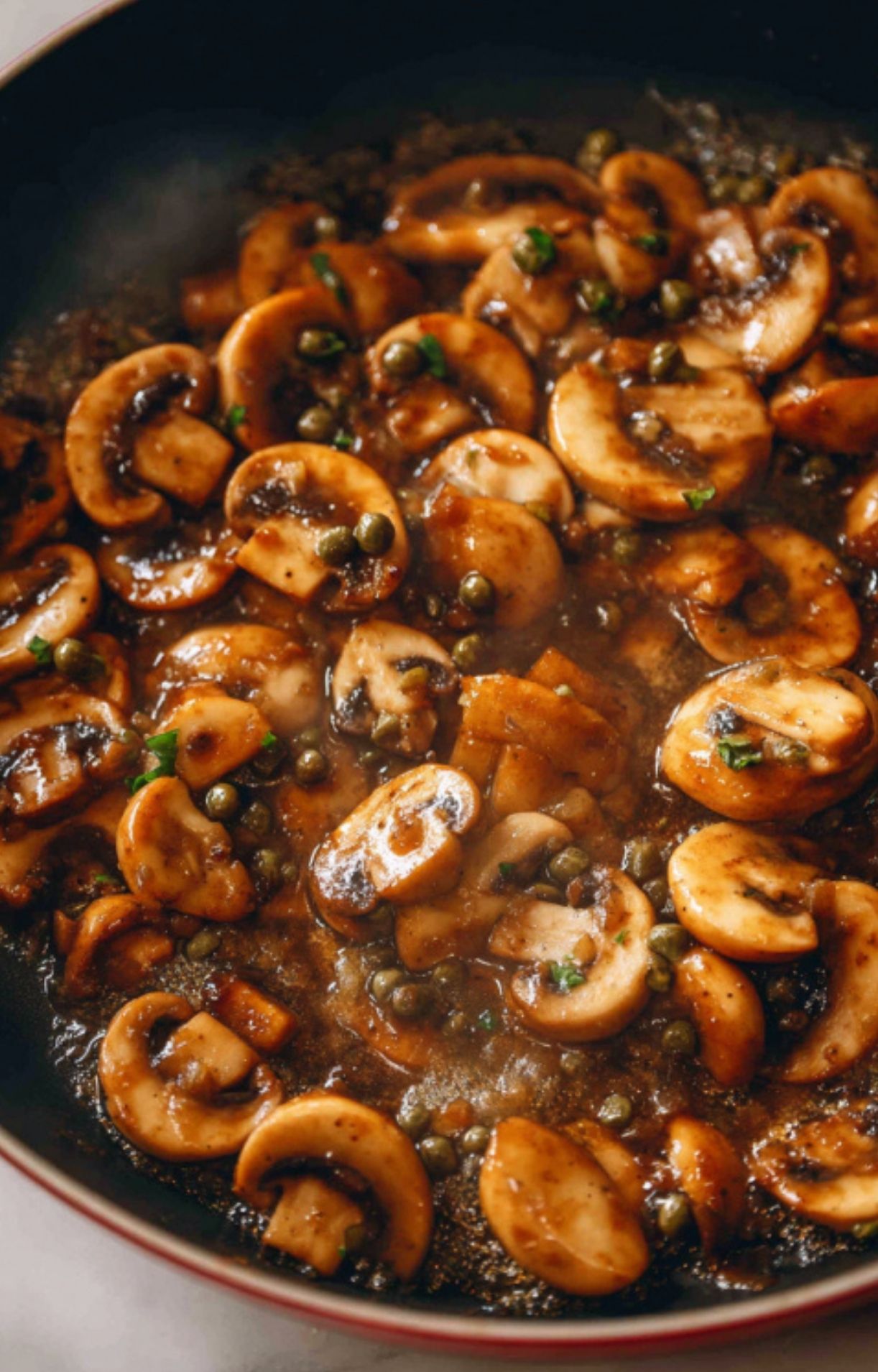 Plate of veal scallopini topped with mushroom sauce, served with arugula and cherry tomatoes. Quick and elegant Italian meal for family dinner.
