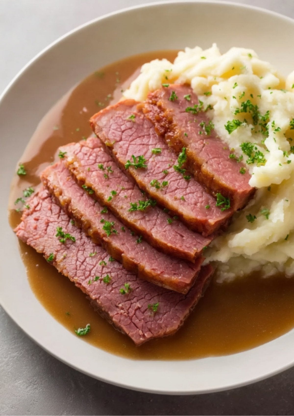 Sliced pressure cooker corned beef served with mashed potatoes and rich brown gravy. A cozy and flavorful meal for St. Patrick&rsquo;s Day or Sunday supper.