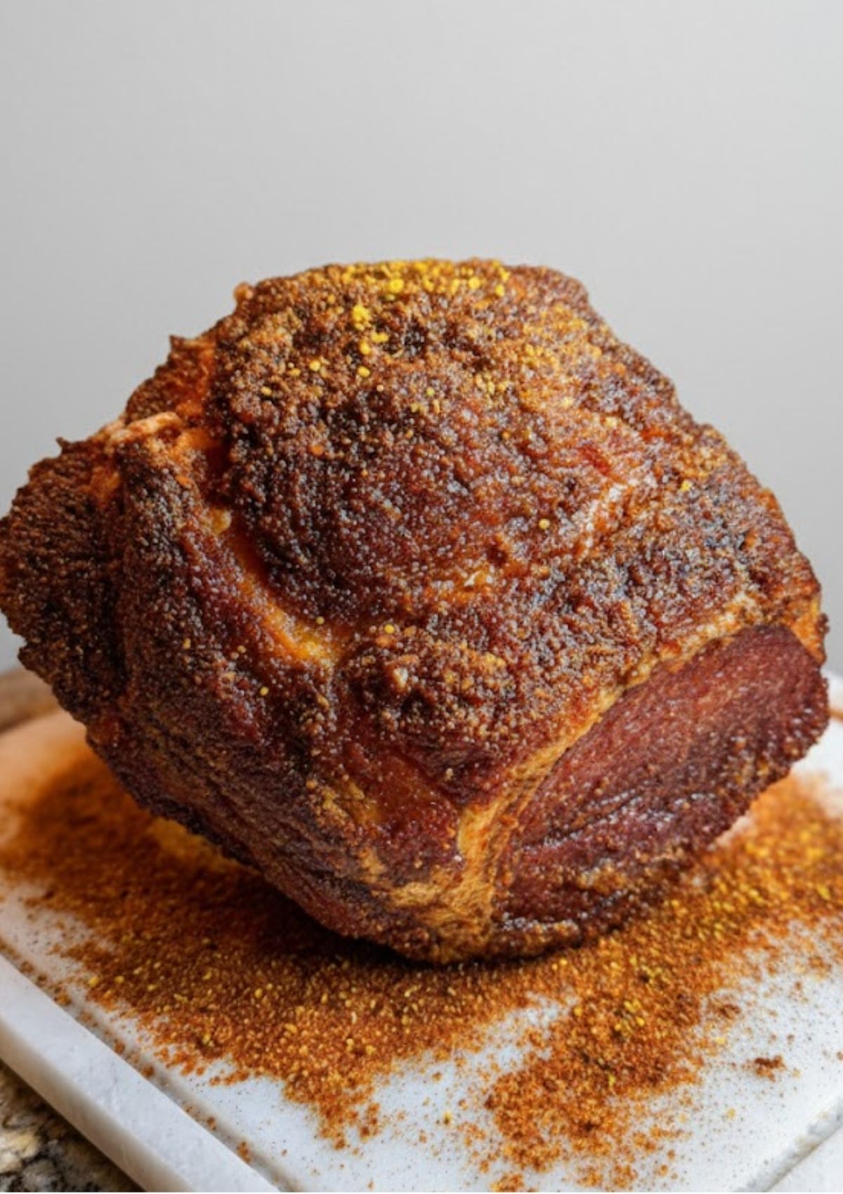 Ham coated with homemade smoked rub, ready for smoking or baking