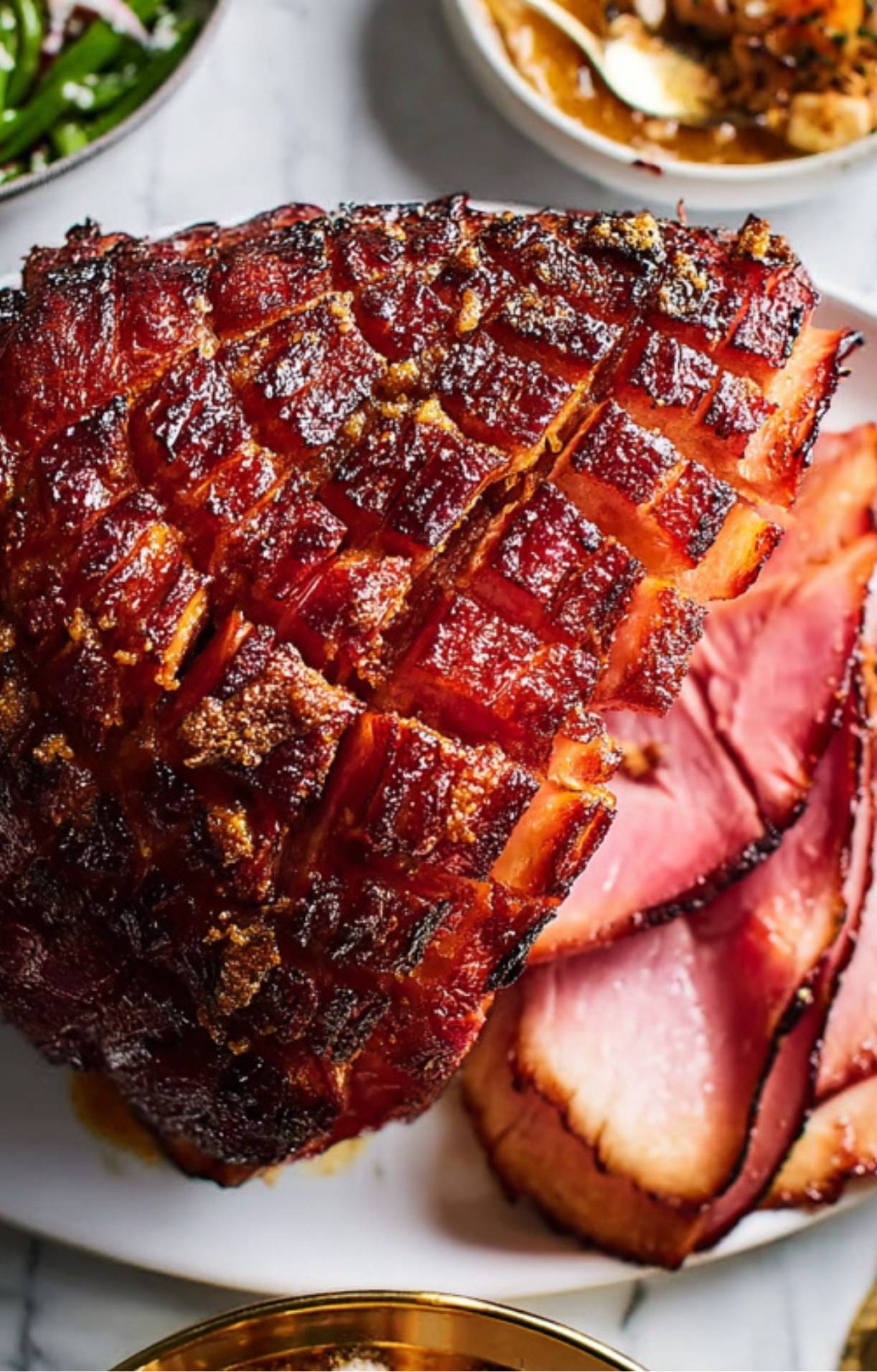 Whole smoked ham with caramelized glaze and crosshatch pattern, sliced for serving, juicy and oven-baked