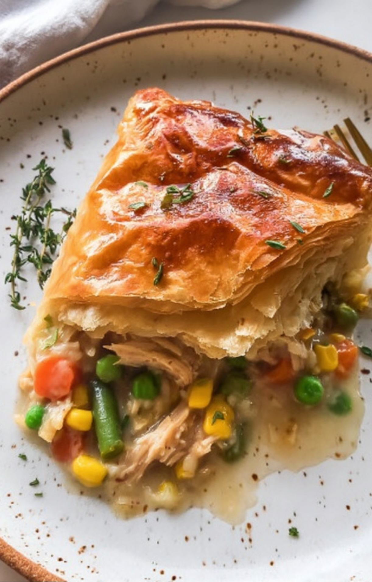 A single serving of Smoked Turkey Pot Pie on a plate, highlighting the tender turkey and colorful vegetables.