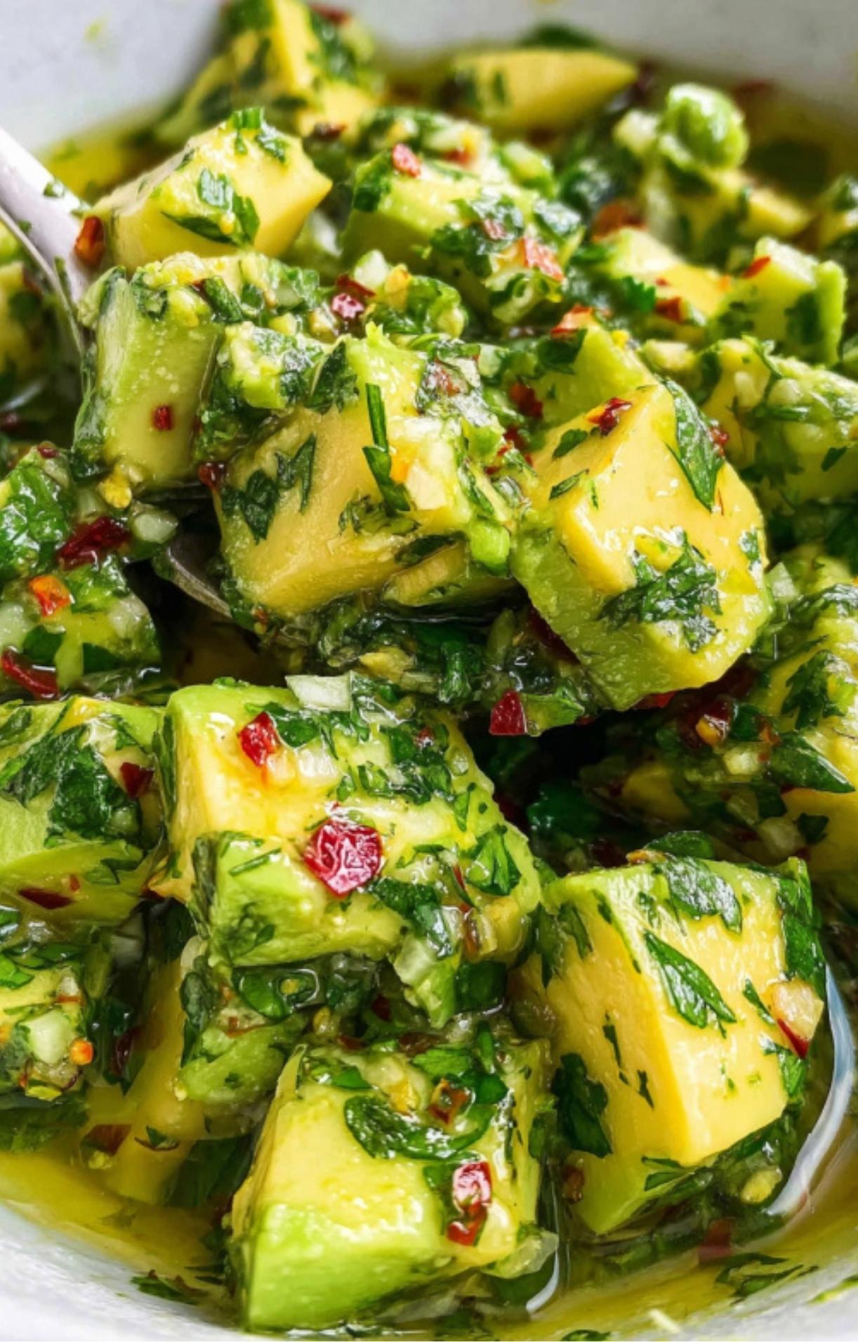 Spoonful of fresh avocado chimichurri with cilantro, parsley, and red pepper flakes. Great as a steak topping, dip, or salad dressing.