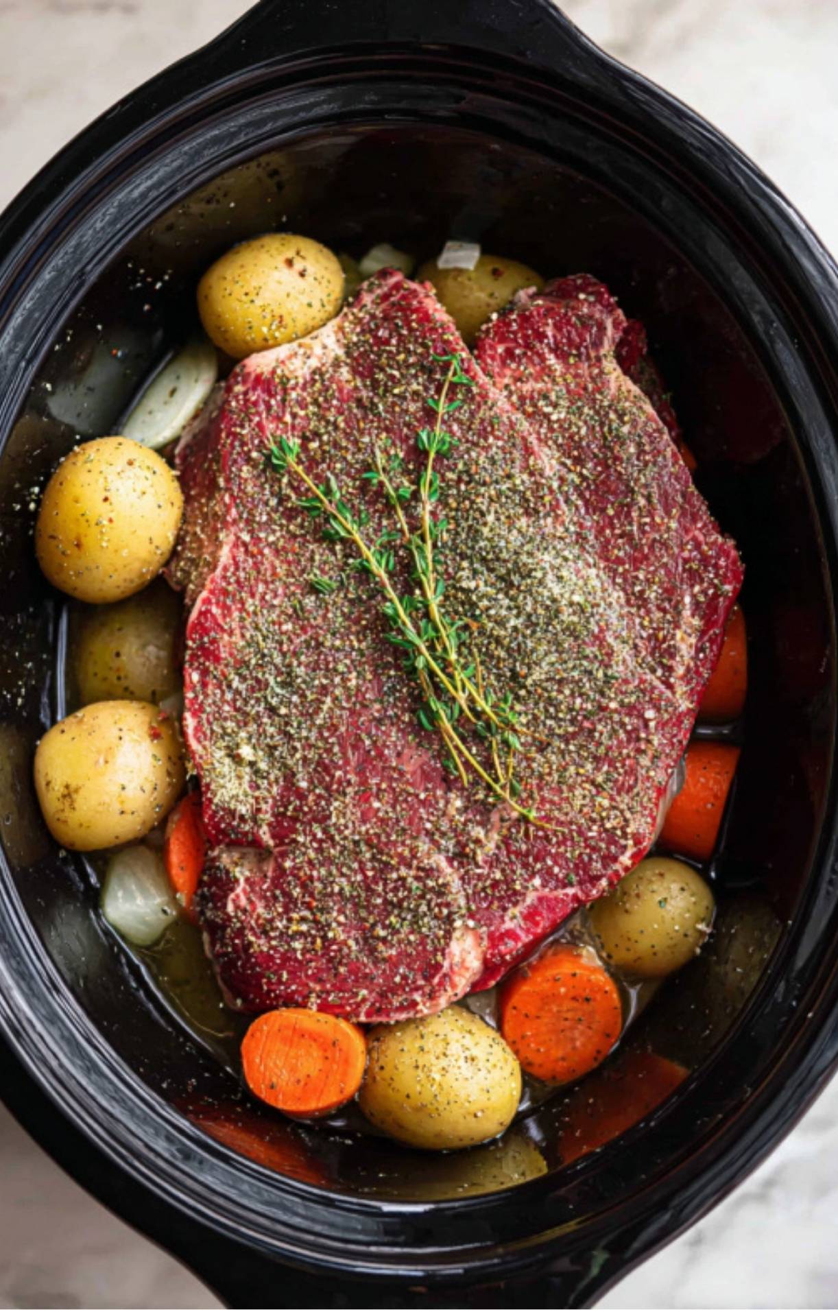The finished roast sitting in a rich, dark brown savory broth with tender vegetables after several hours of slow cooking.