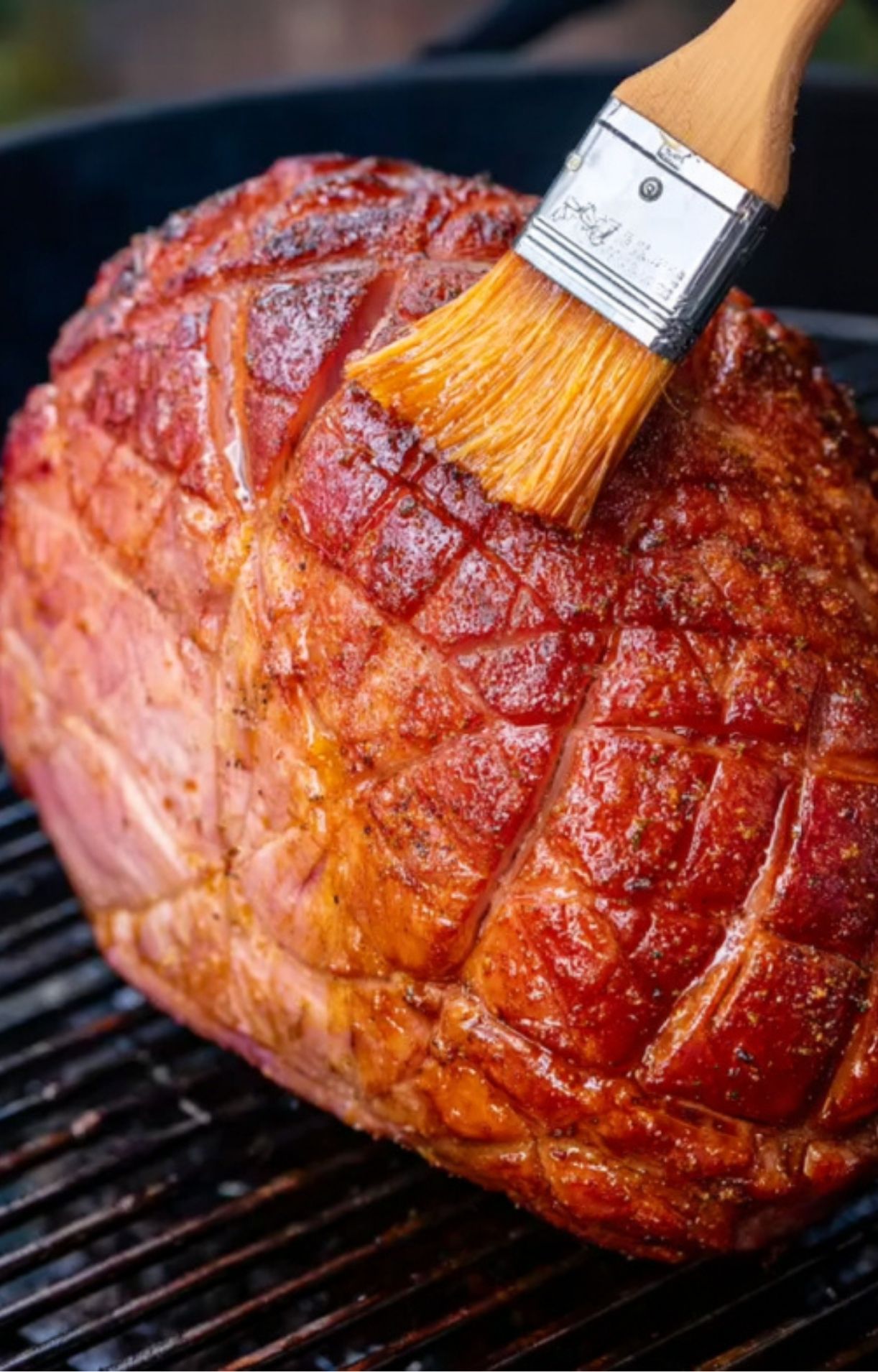 Brushing glaze over smoked ham for juicy flavor