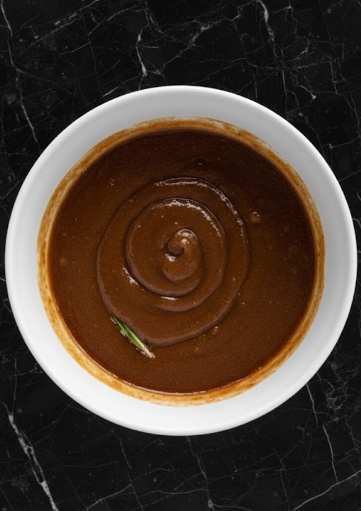 Bowl of thick brown sugar maple ham glaze, perfect for Christmas or Easter ham