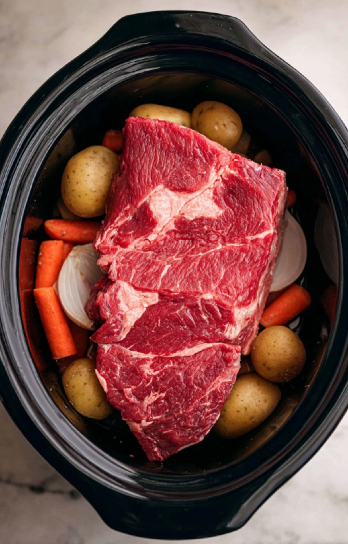 The cooked chuck roast broken into large, succulent chunks and mixed with the softened vegetables and juices.