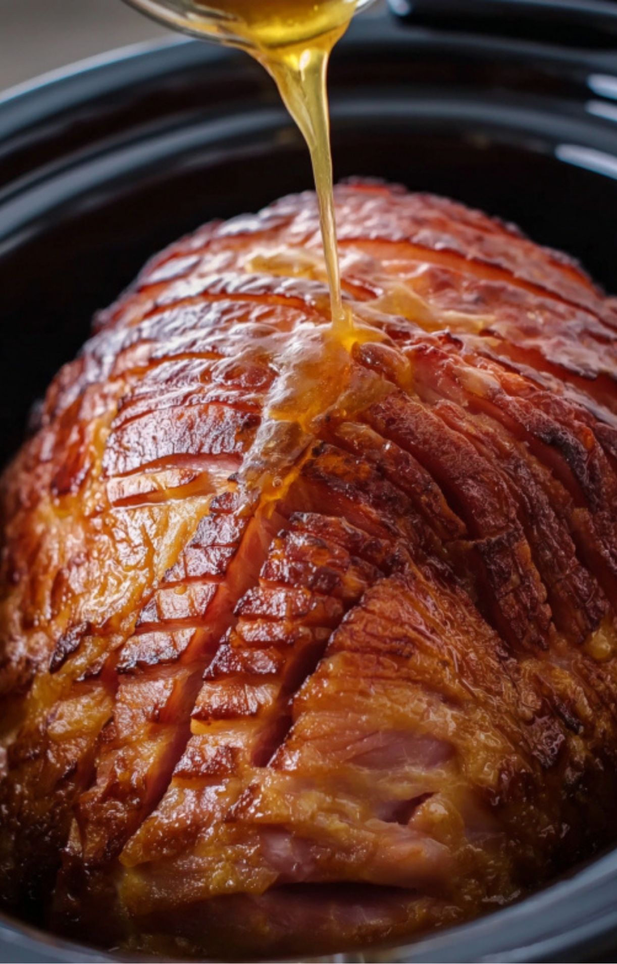 Sweet glaze being poured onto spiral ham in a crock pot, ready to absorb flavor for juicy slices.