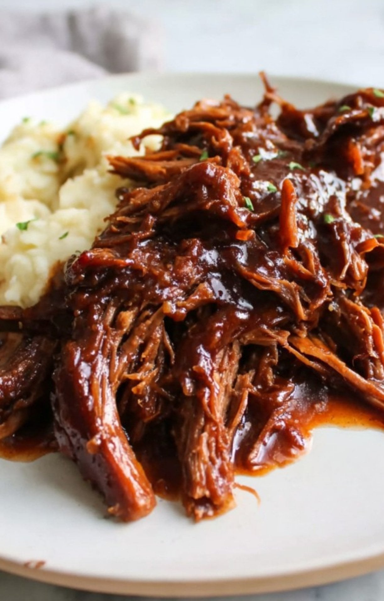 A delicious serving of slow cooker smoked brisket paired with creamy mashed potatoes and extra gravy.
