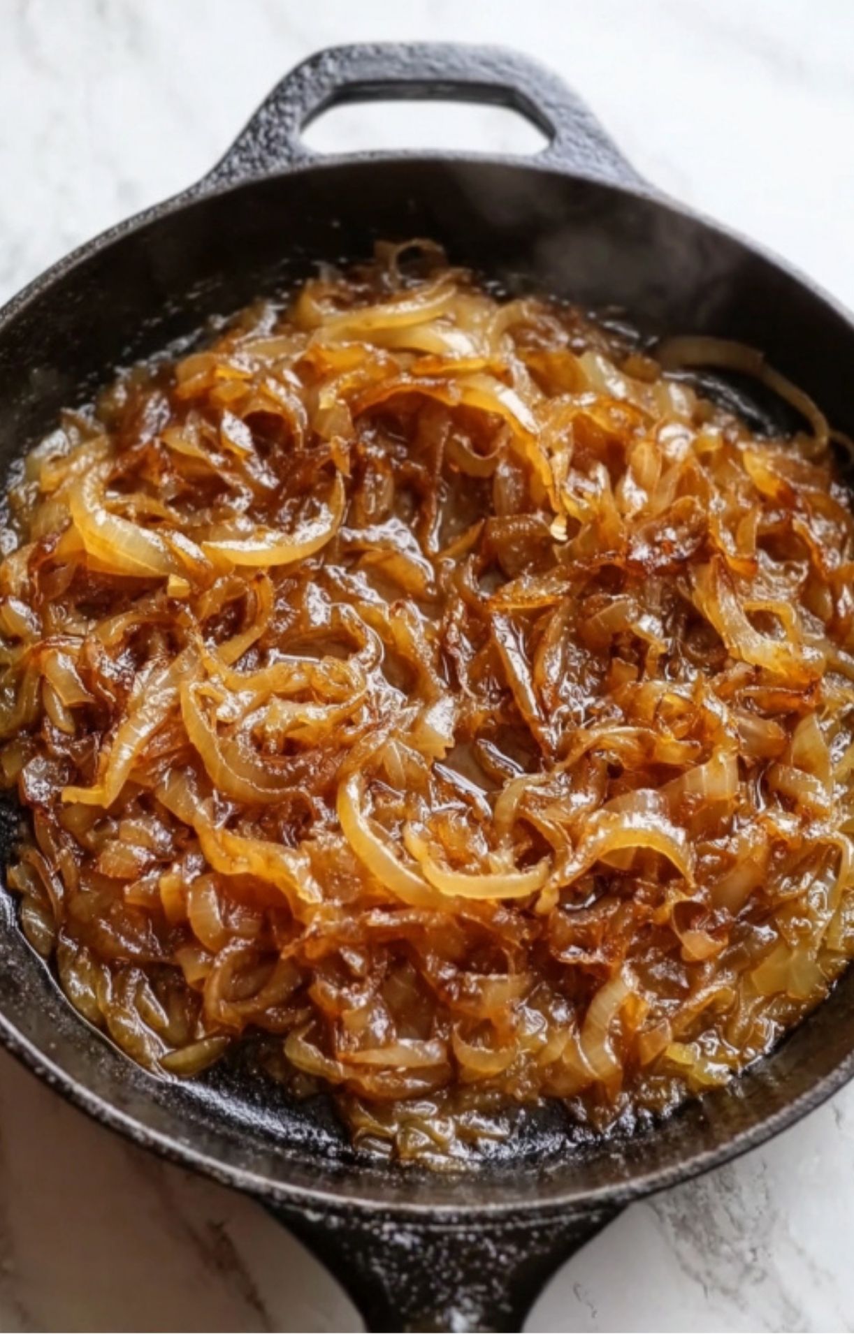 Thinly sliced onions sautéed in a cast iron skillet until deep golden brown and caramelized.