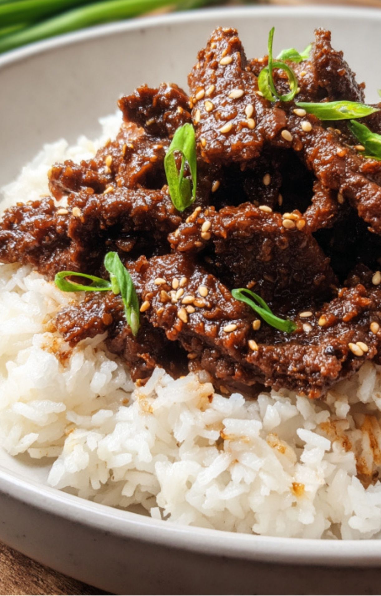 A close-up shot of the finished Air Fryer Beijing Beef served over a bed of fluffy white rice.