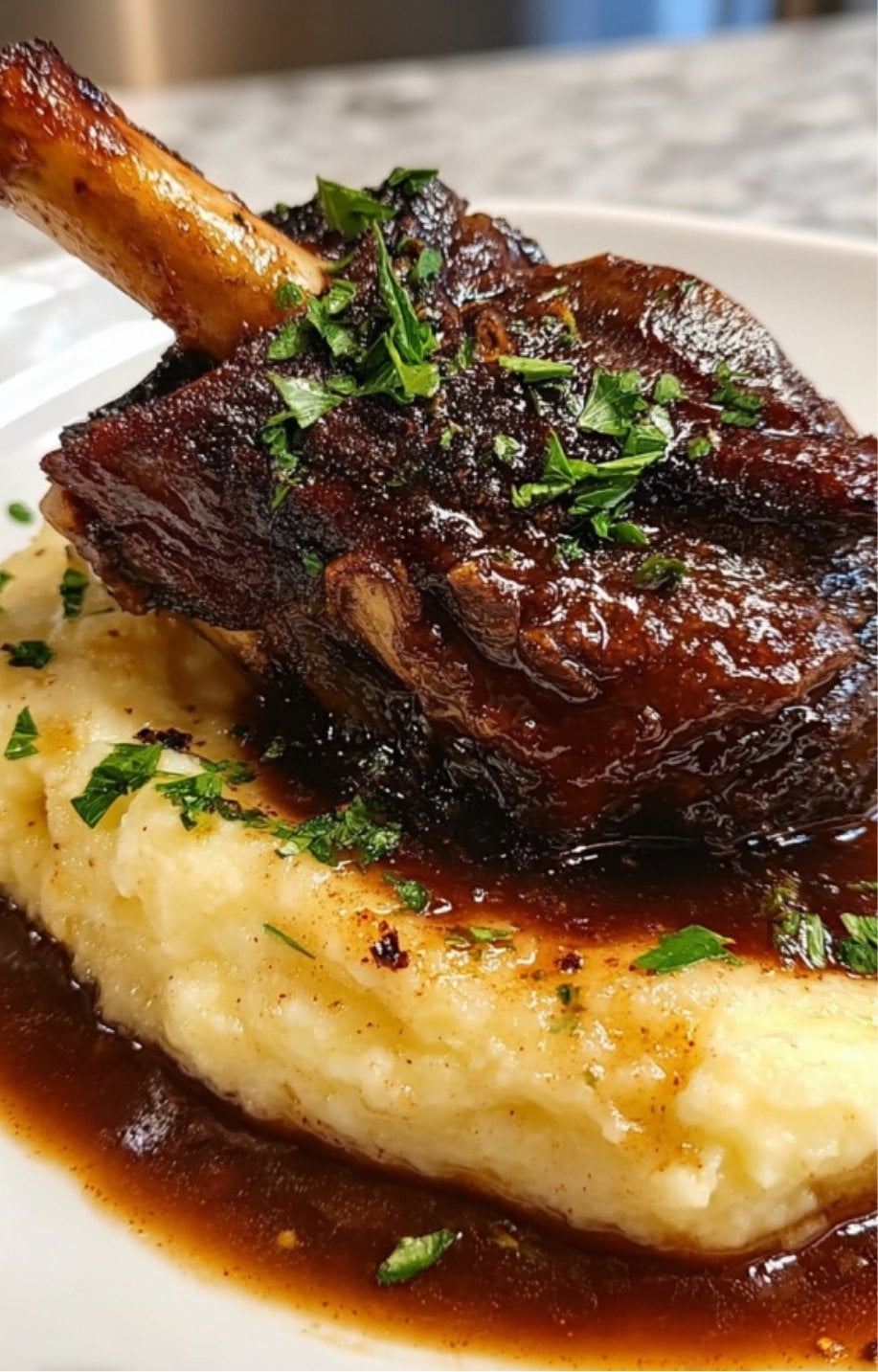 A detailed shot of the crispy, caramelized exterior of a lamb shank topped with parsley.