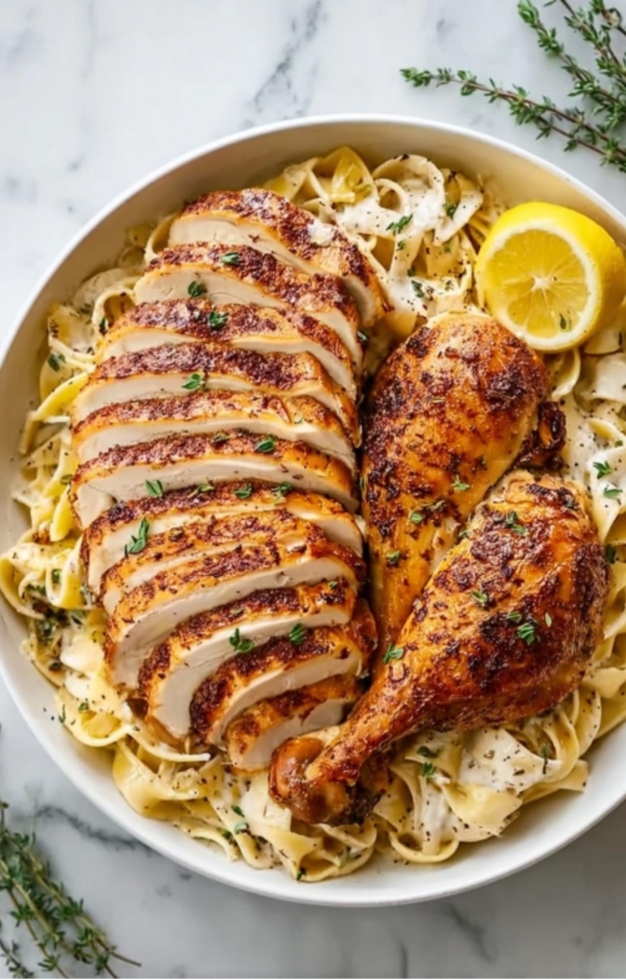 Juicy slices of smoked chicken breast and a drumstick served over creamy fettuccine pasta with lemon.