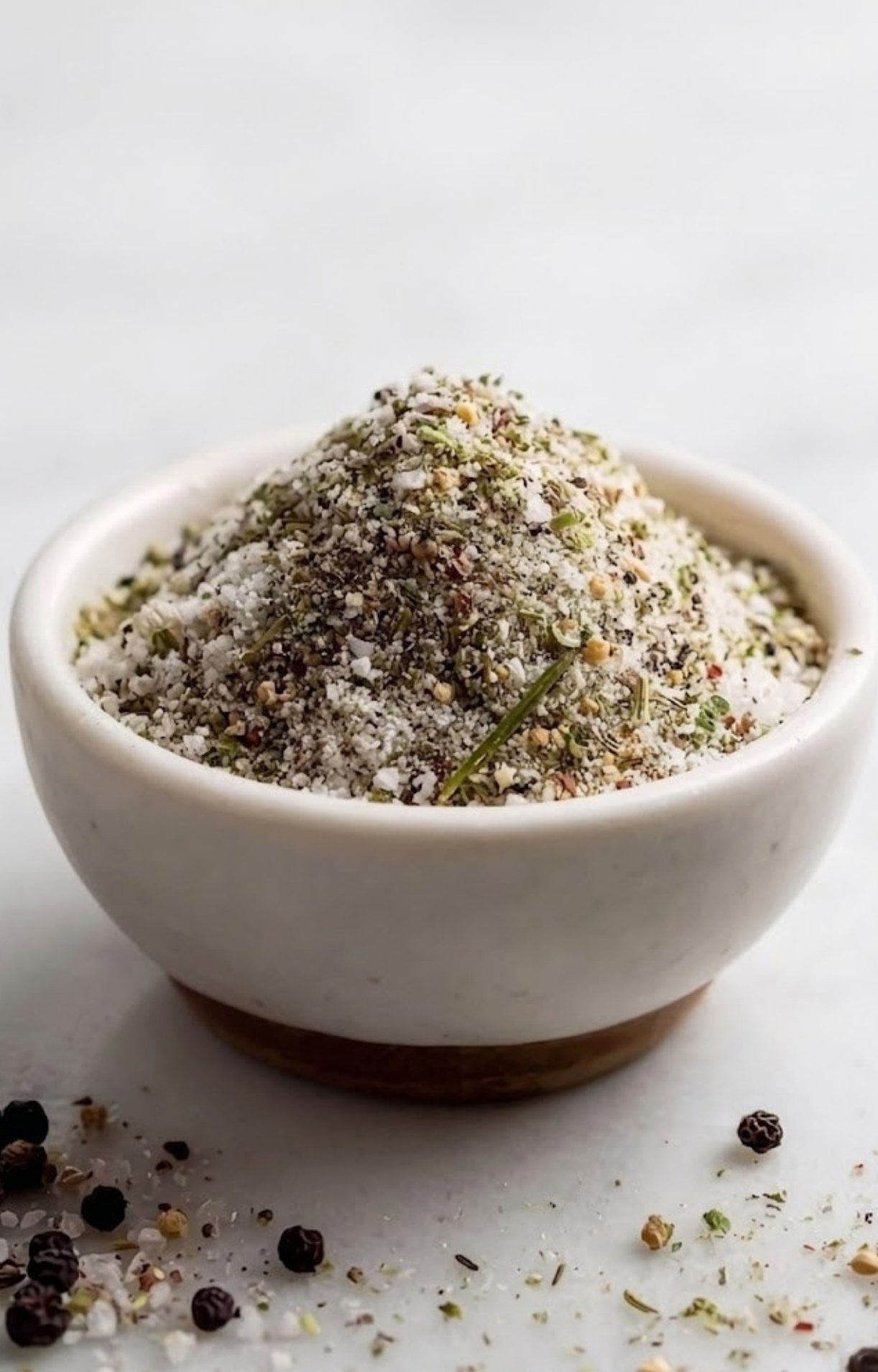 A macro shot of a mounded pile of Smoked Tomahawk Steak Rub in a bowl, highlighting the grains of salt and cracked pepper.