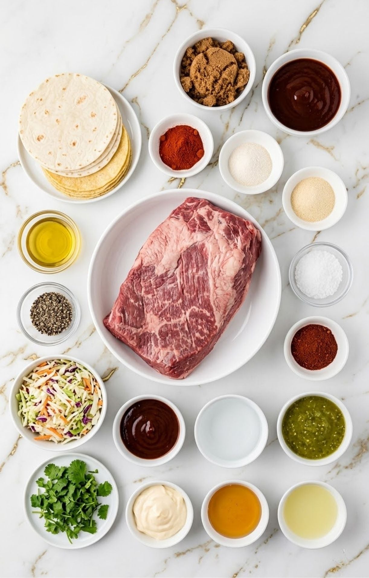 A top-down flat-lay shot on a white marble background featuring a raw beef brisket in a white bowl surrounded by small bowls of tortillas, cabbage slaw, cilantro, barbecue sauce, and various dry spices.