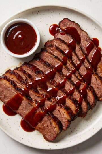 tender wagyu beef brisket recipe sliced brisket served with bbq sauce on plate tender and moist