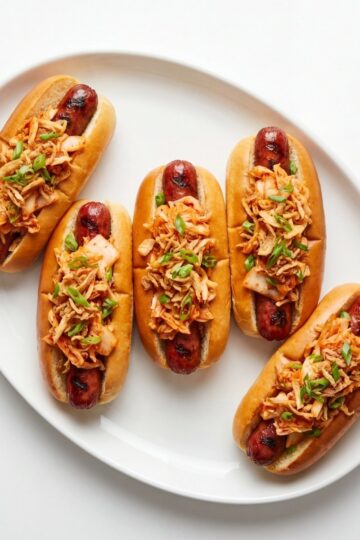 wagyu beef hot dogs served on plate with kimchi slaw topping perfect BBQ party food idea