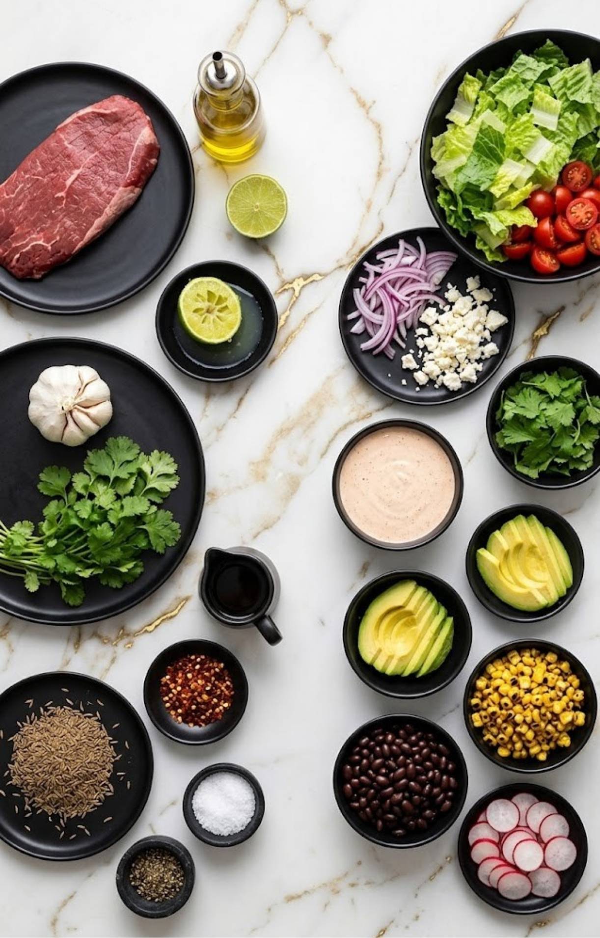 An organized spread of ingredients for a Flank Steak Salad Recipe, including steak, avocado, beans, corn, and spices.
