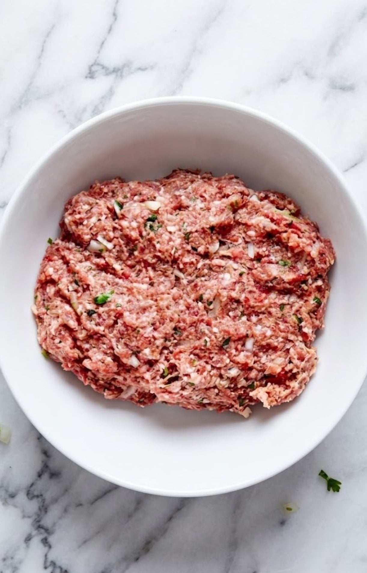 The meatball ingredients fully combined in a bowl ready to be rolled into air fryer beef meatballs.