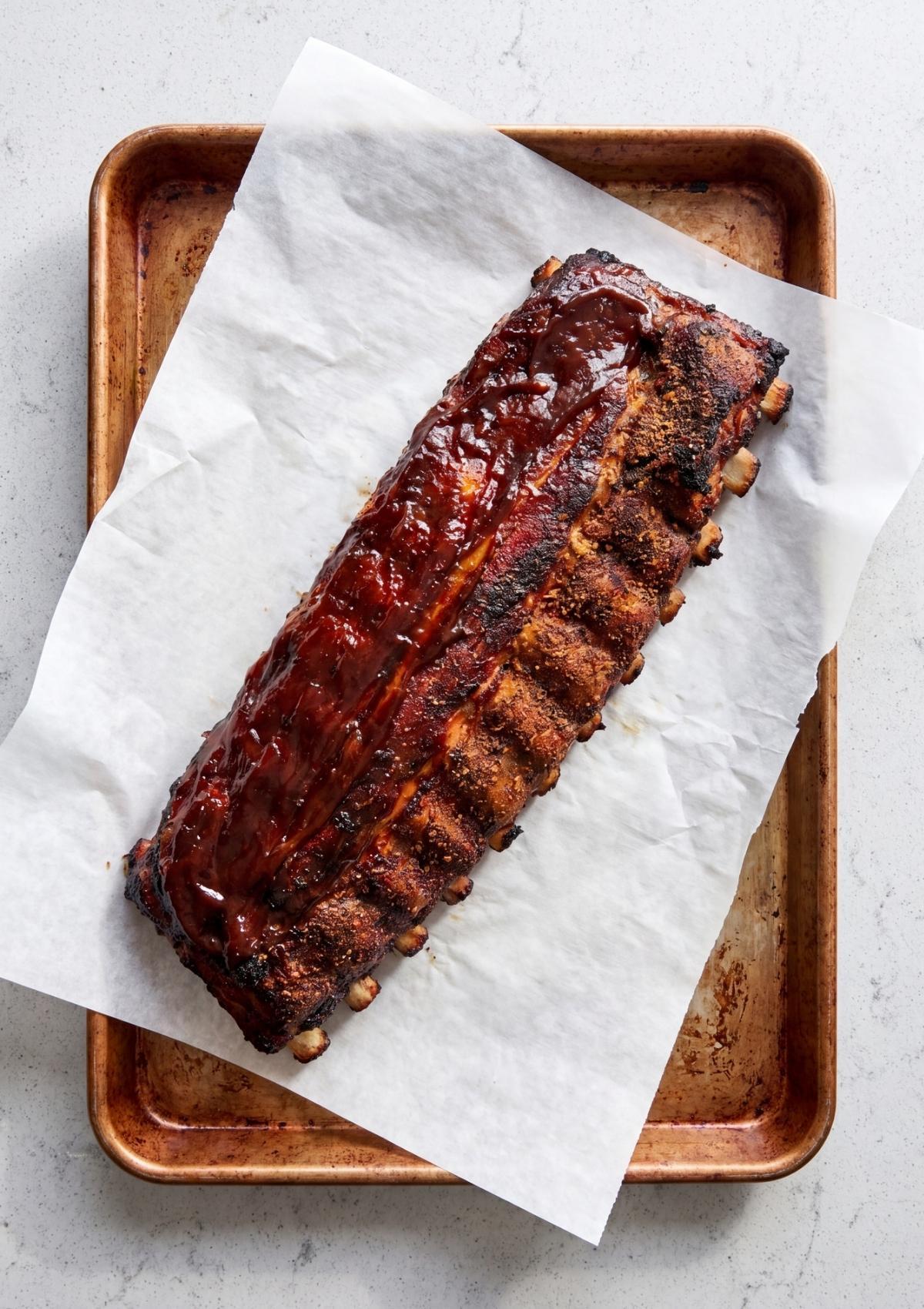 full rack of smoked ribs with caramelized bbq sauce on tray best smoked ribs recipe pellet grill