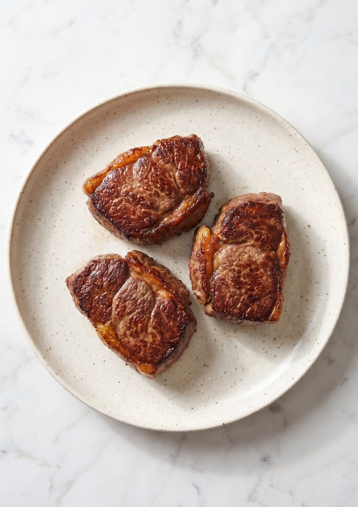 wagyu beef cheek pieces seared in pan for wagyu beef cheek recipe golden crust step