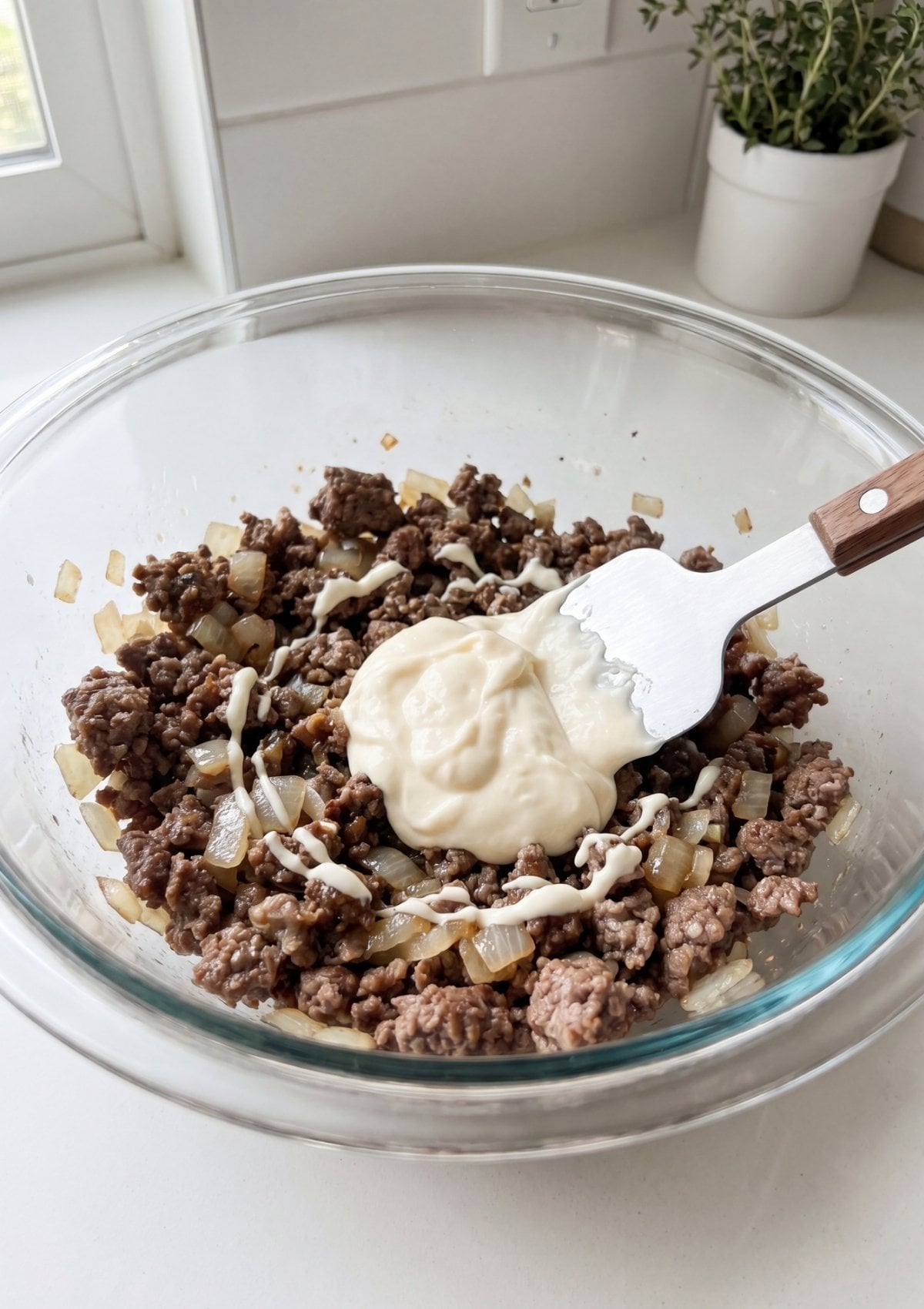 wagyu beef slider filling mixed with caramelized onions and creamy sauce in bowl