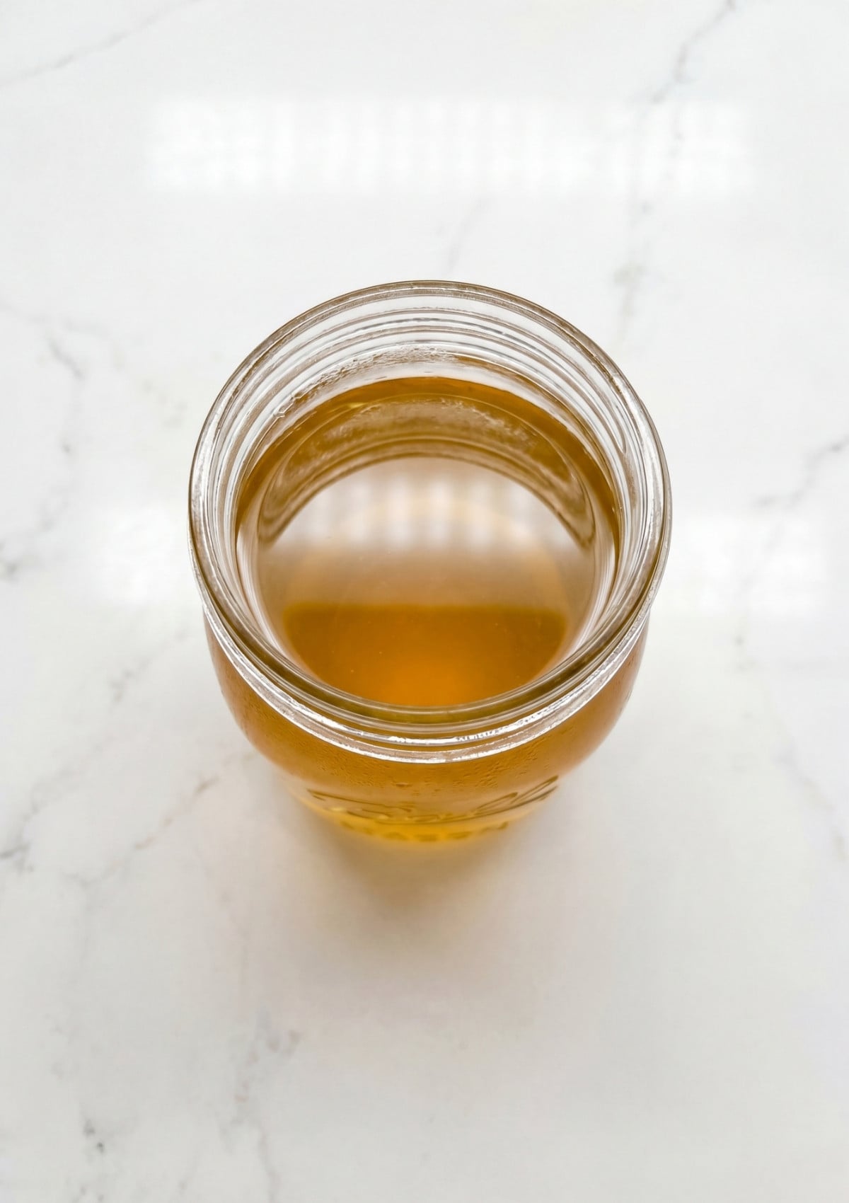 golden wagyu beef tallow liquid in jar from wagyu beef tallow recipe rich cooking fat close up