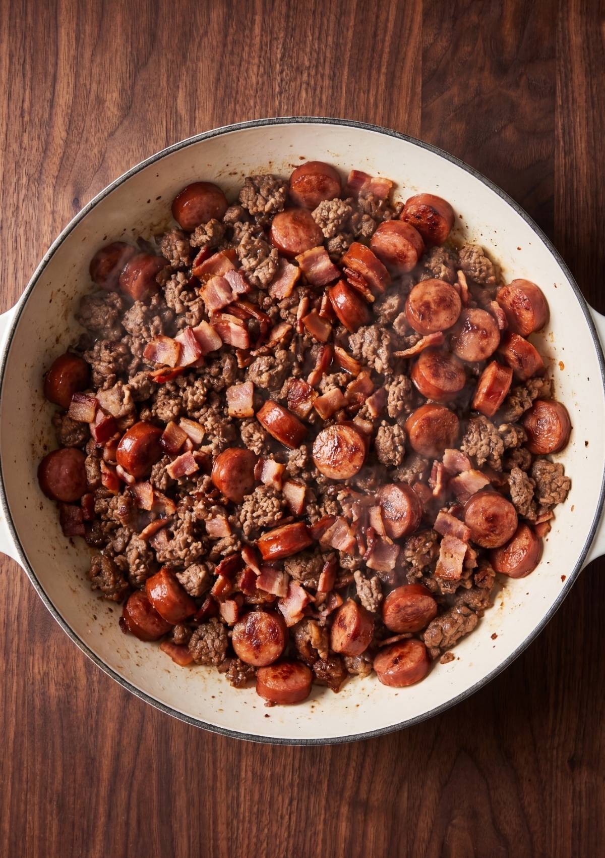 ground beef sausage and bacon cooking together for one pot cowboy spaghetti