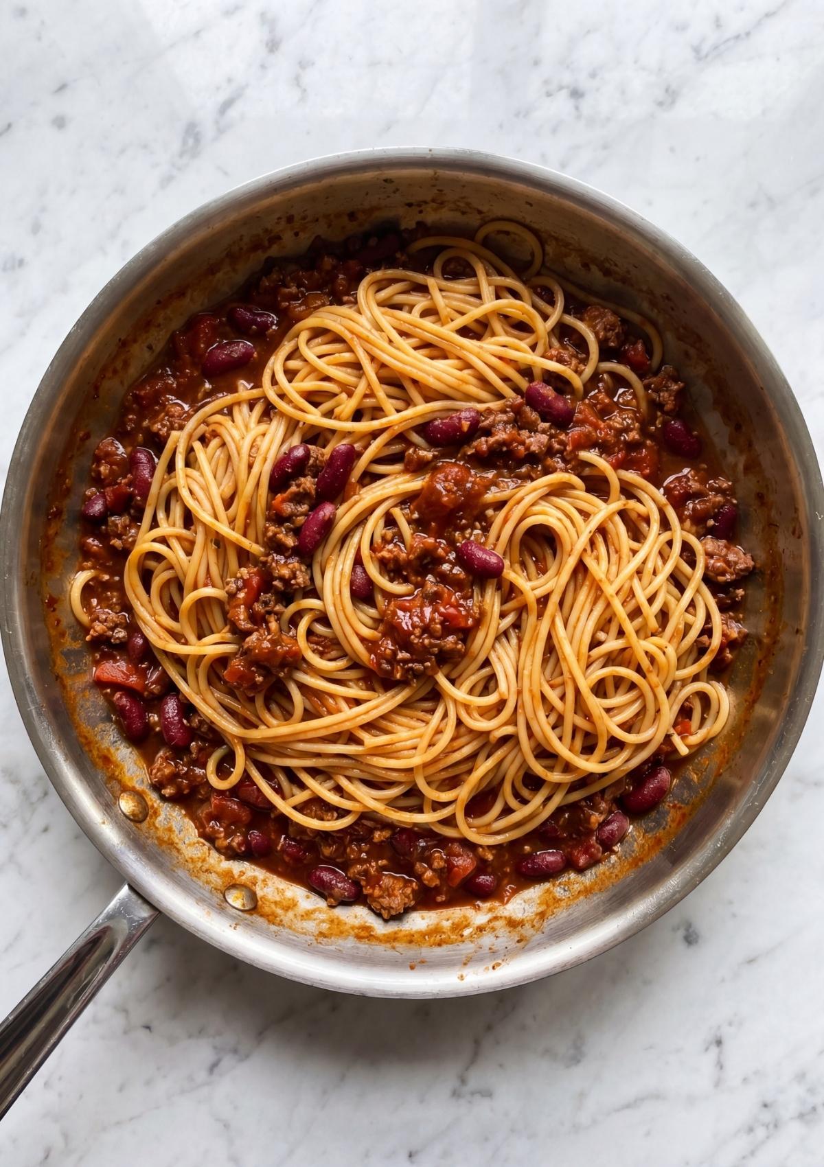 spaghetti mixed with beef beans and sauce for cowboy spaghetti with bacon hearty comfort food