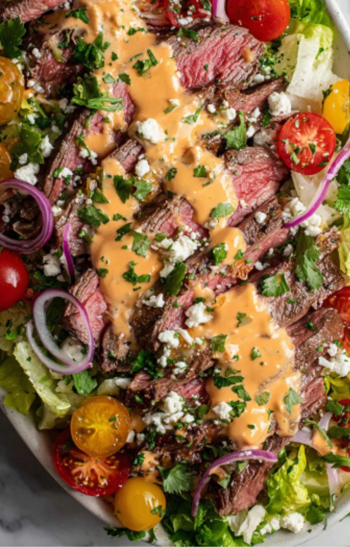 An extreme close-up of a Flank Steak Salad Recipe showing the textures of the meat, dressing, and fresh cilantro.
