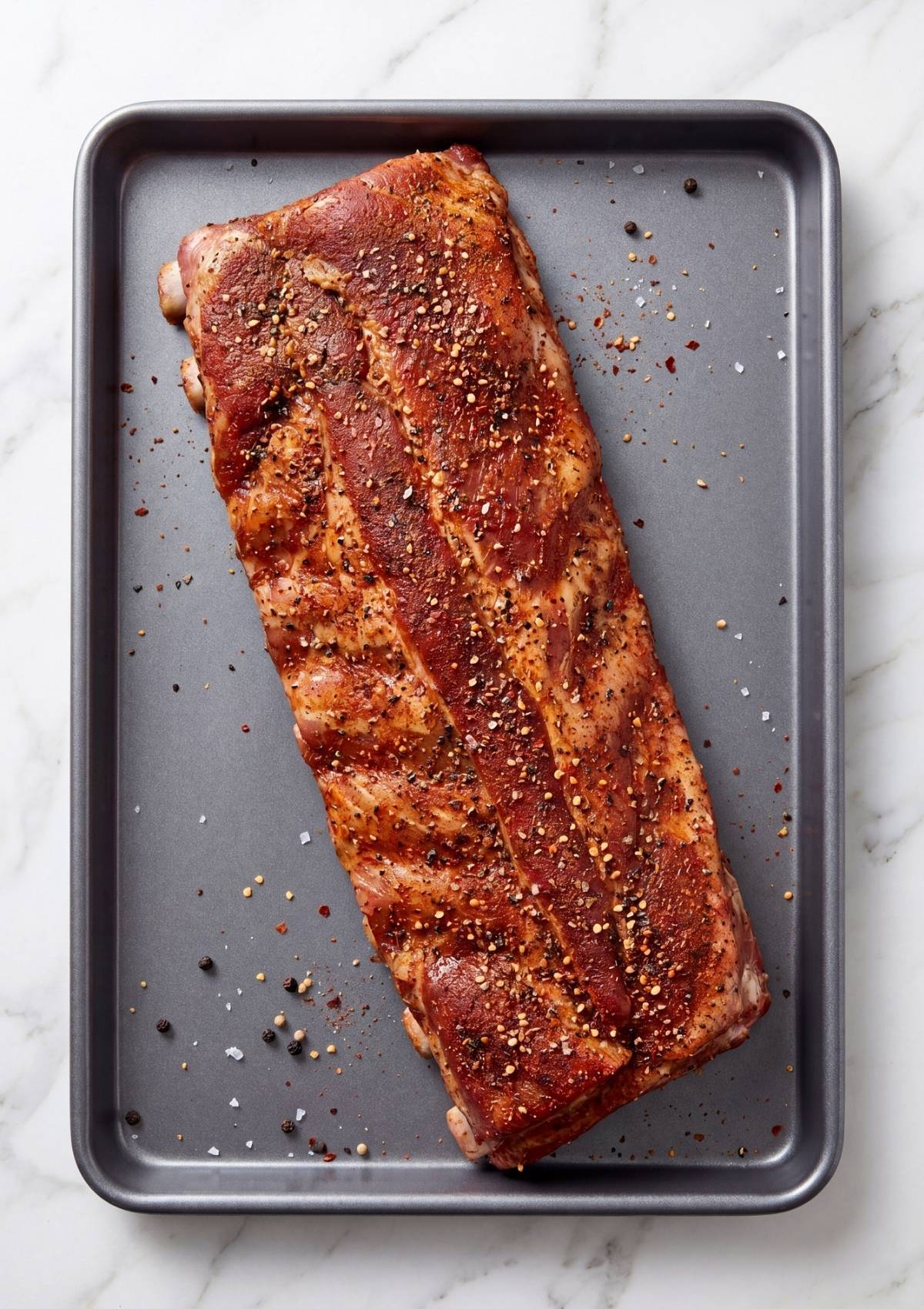 raw pork spare ribs seasoned with spices ready for pellet smoker cooking